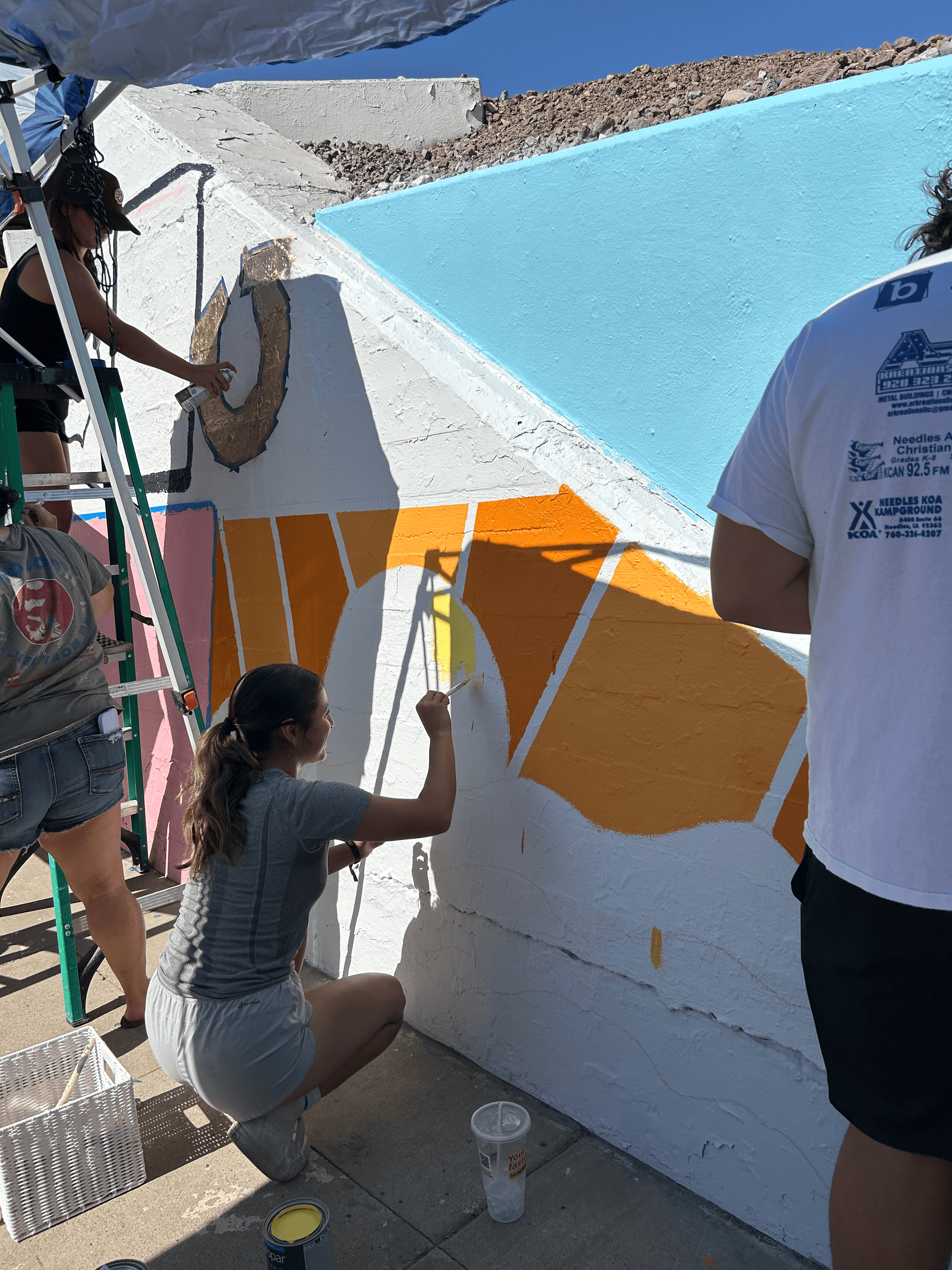 Students painting underpass.