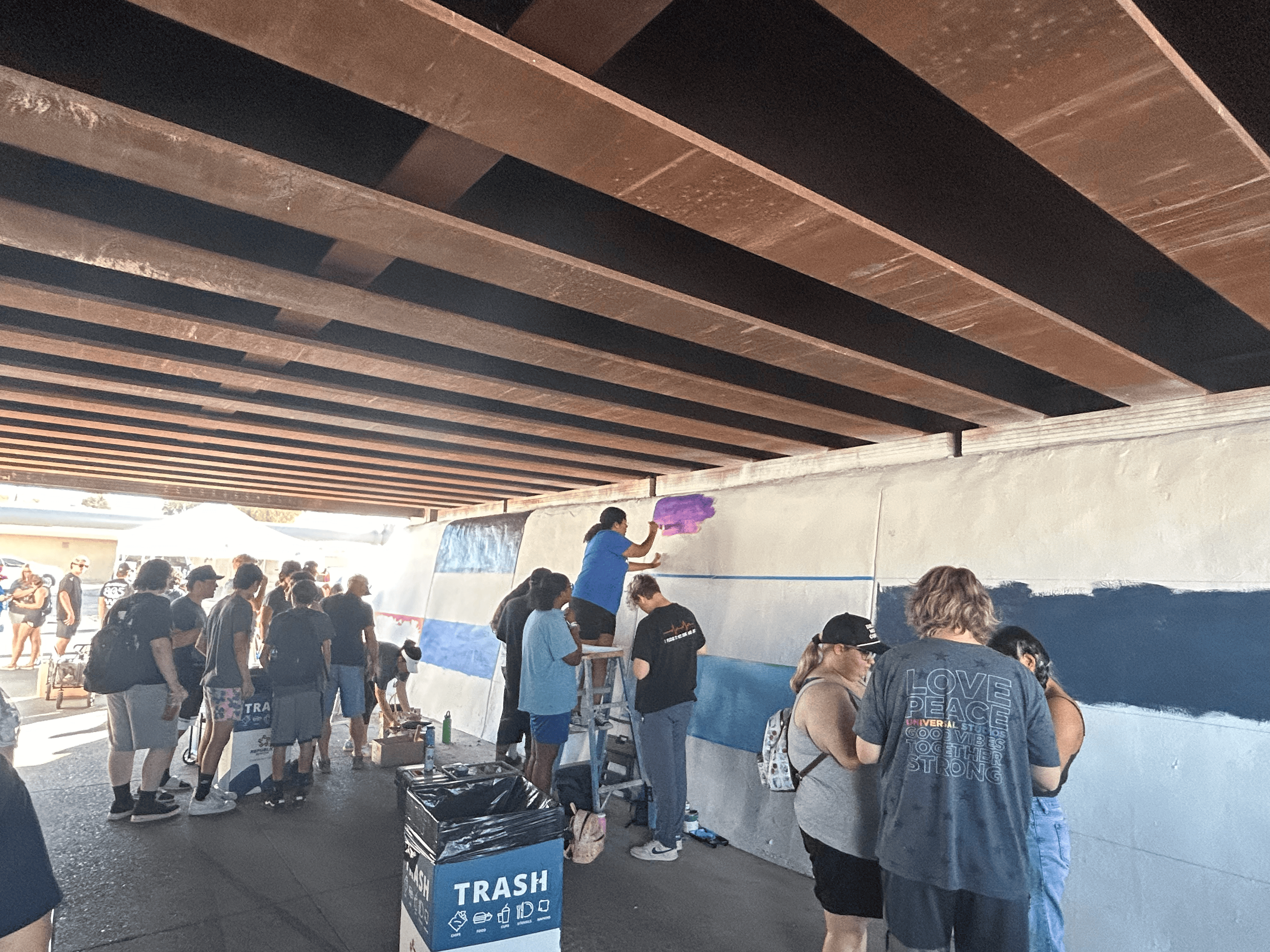 Students painting underpass.