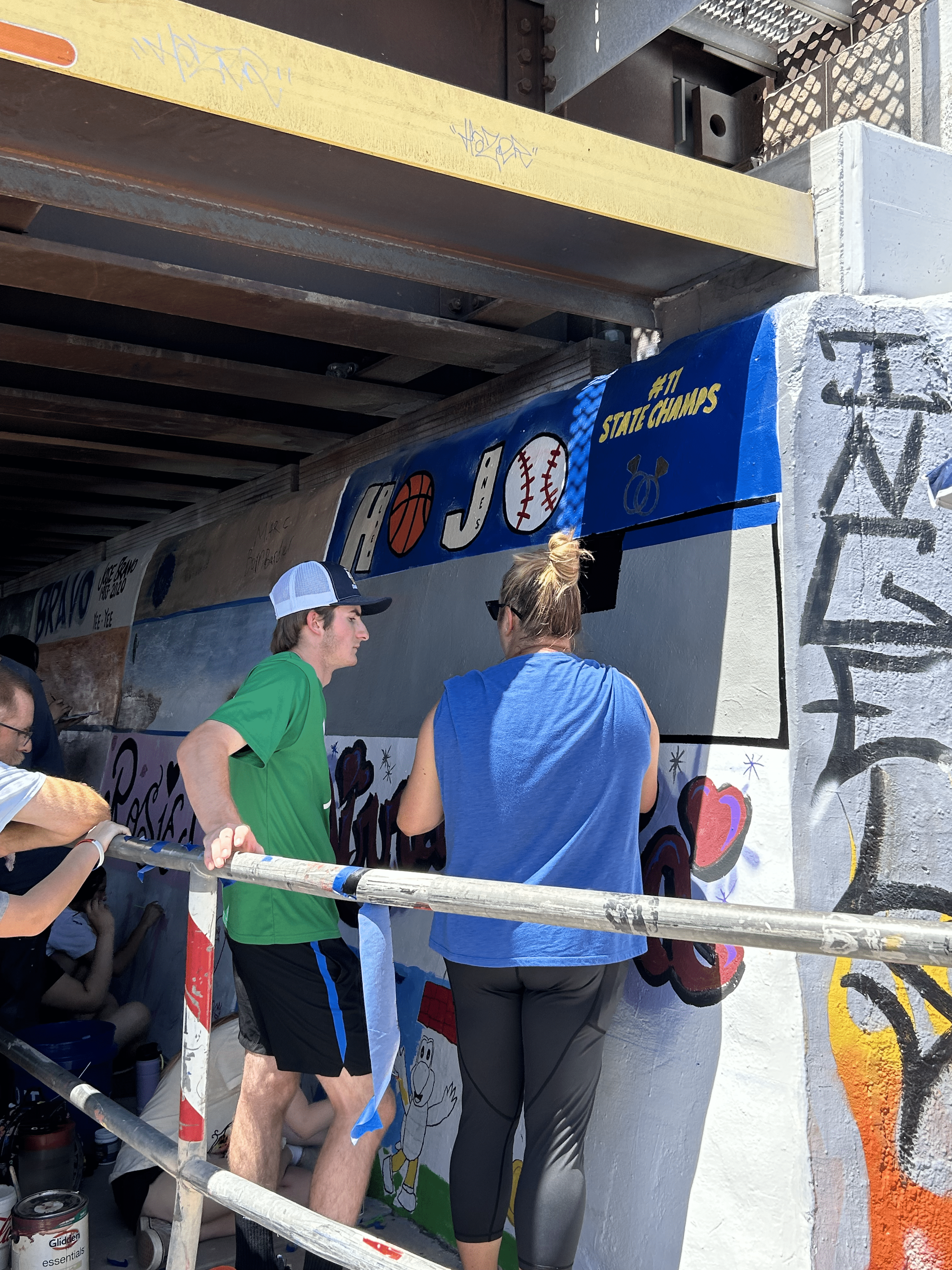 Students painting underpass.