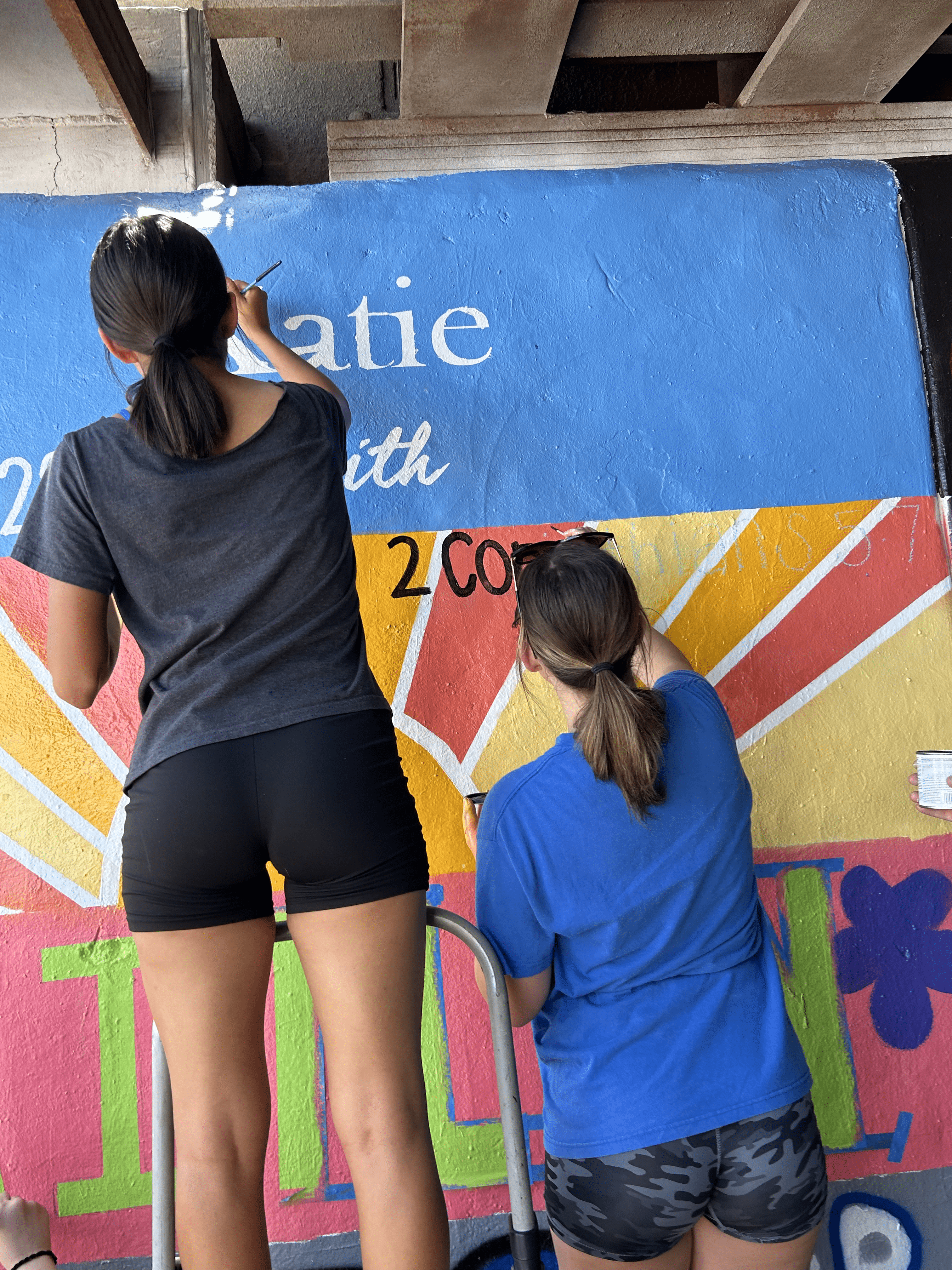 Students painting underpass.