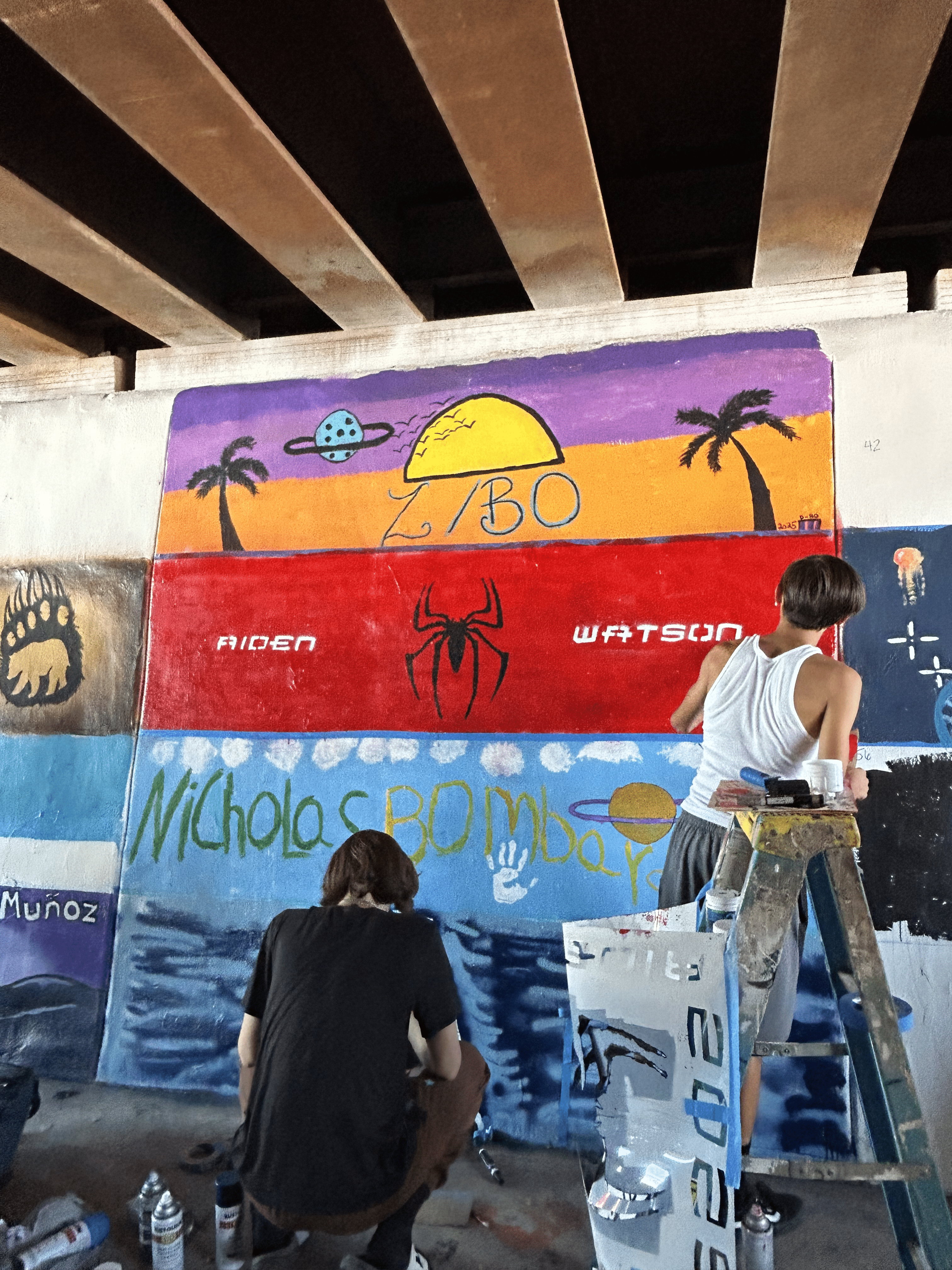 Students painting underpass.