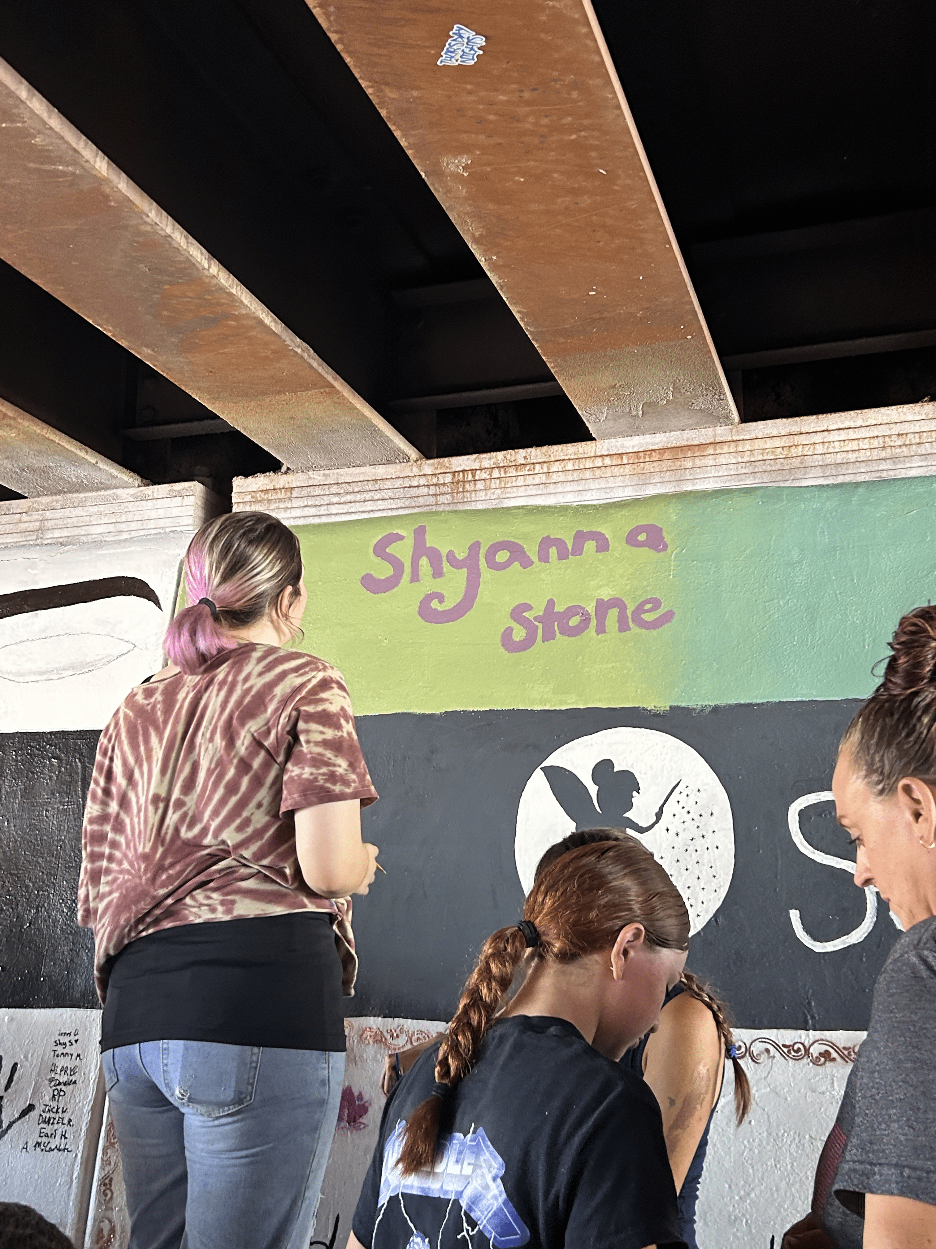 Students painting underpass.