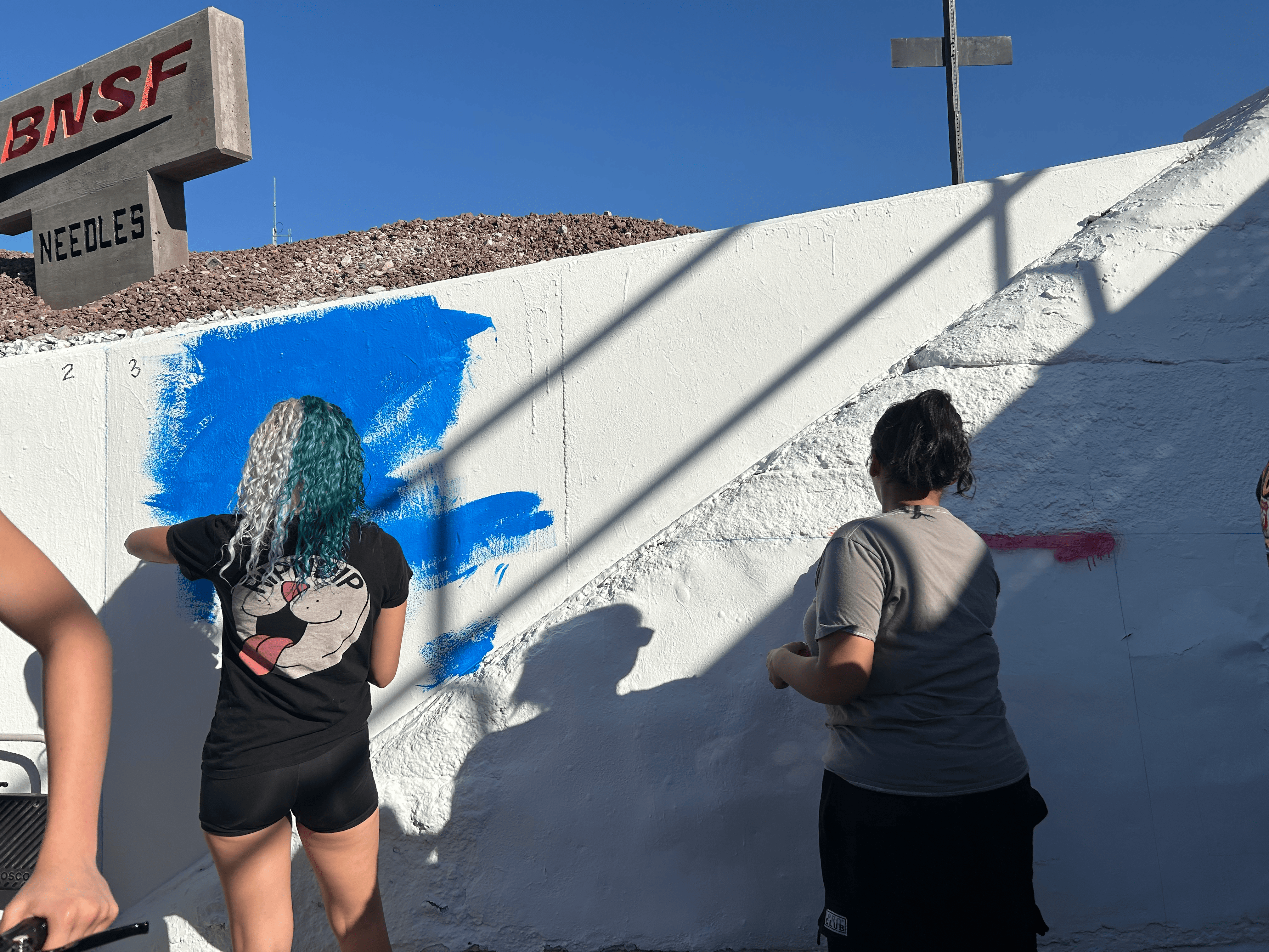 Students painting underpass.