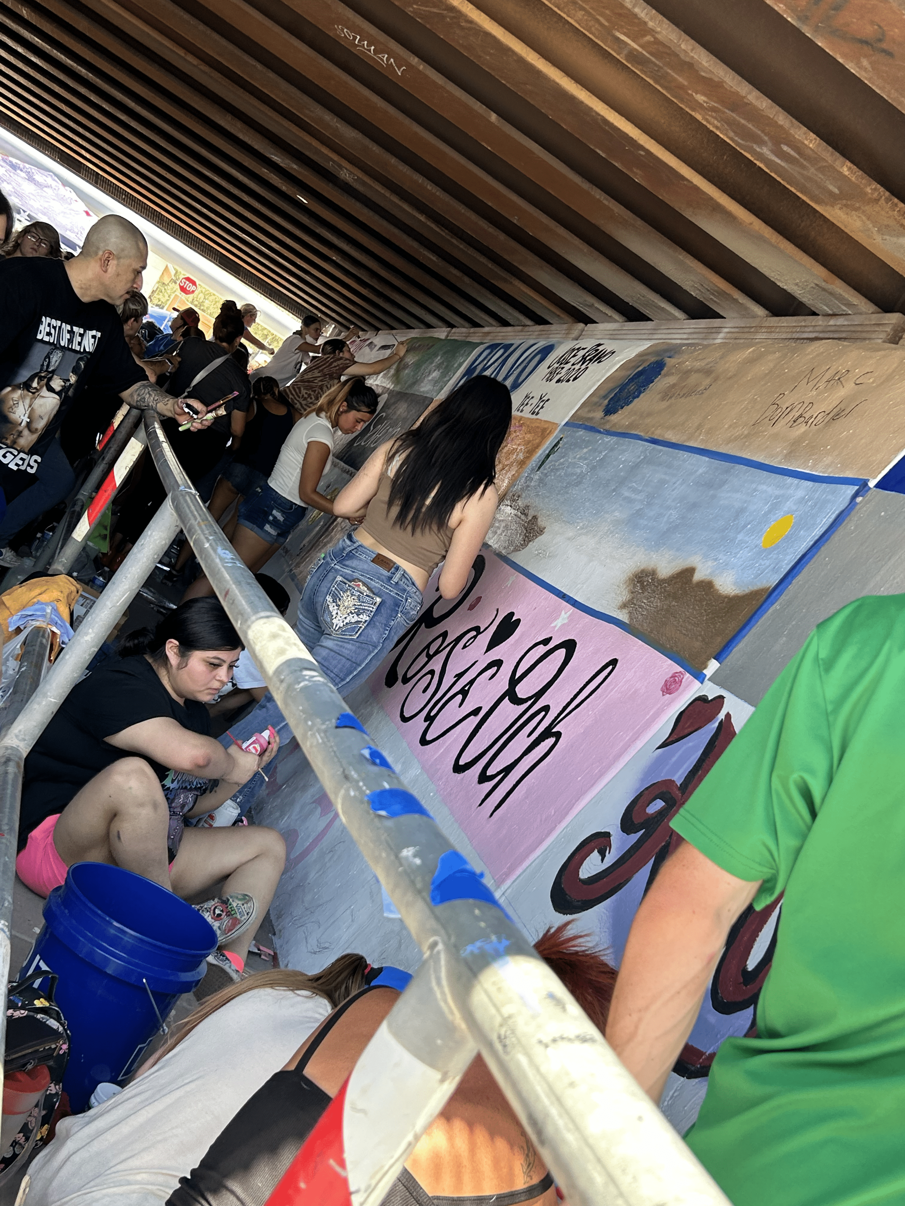 Students painting underpass.