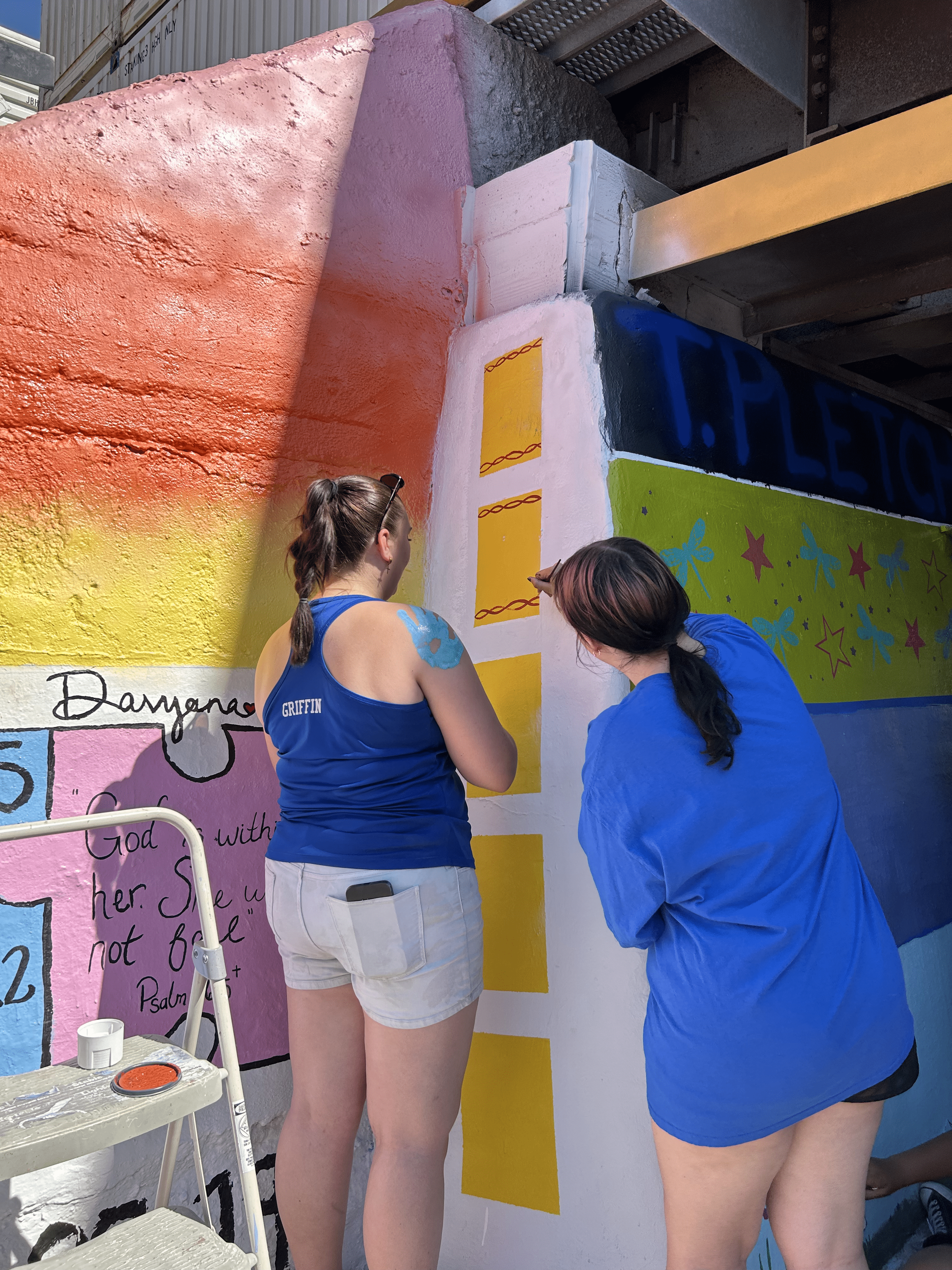 Students painting underpass.