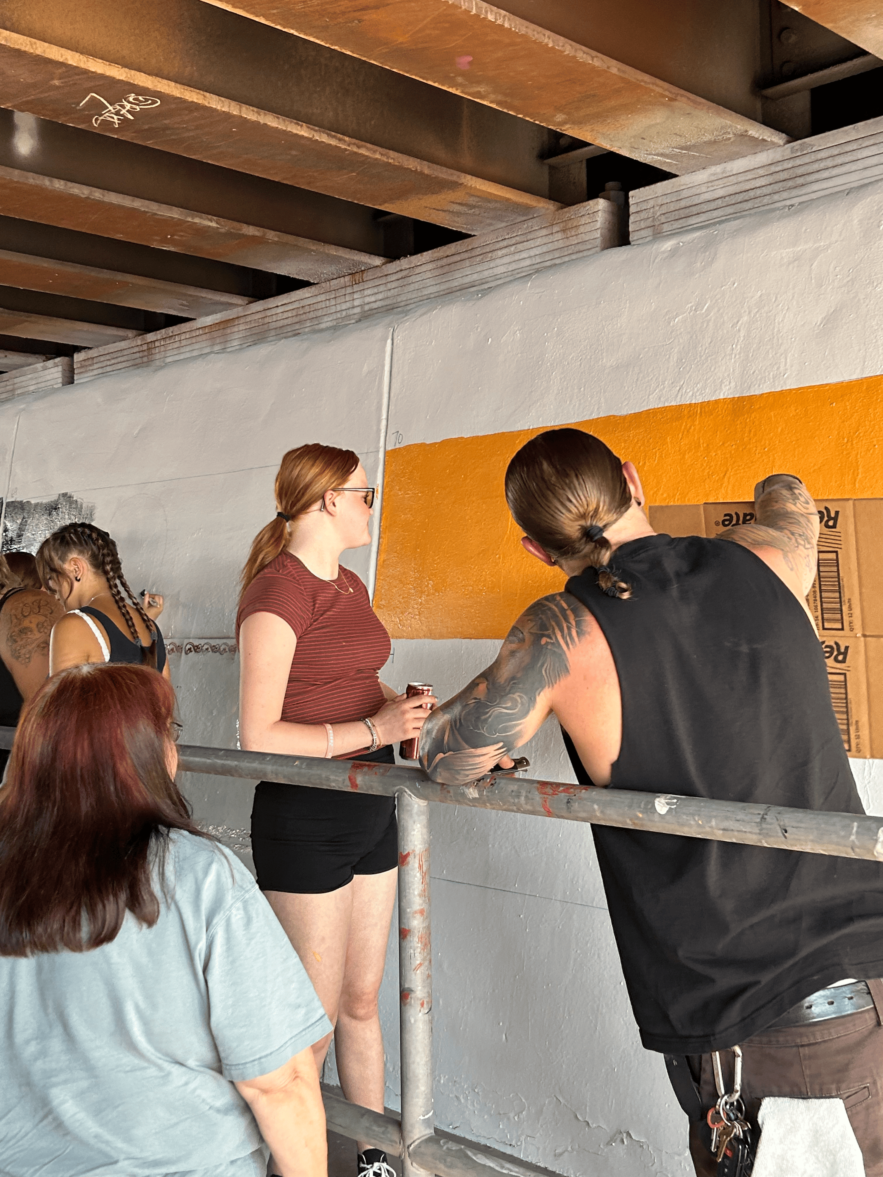 Students painting underpass.