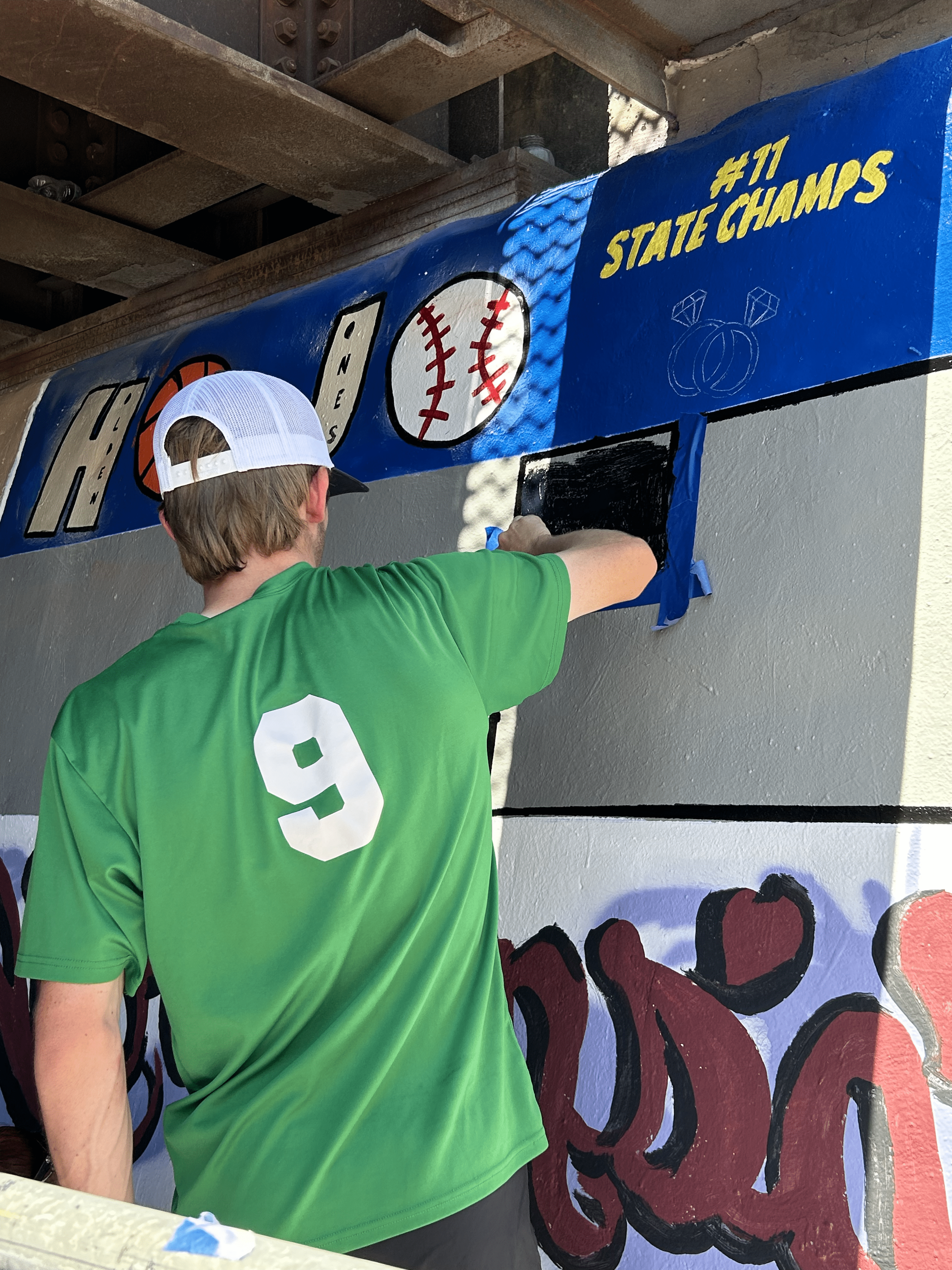 Students painting underpass.