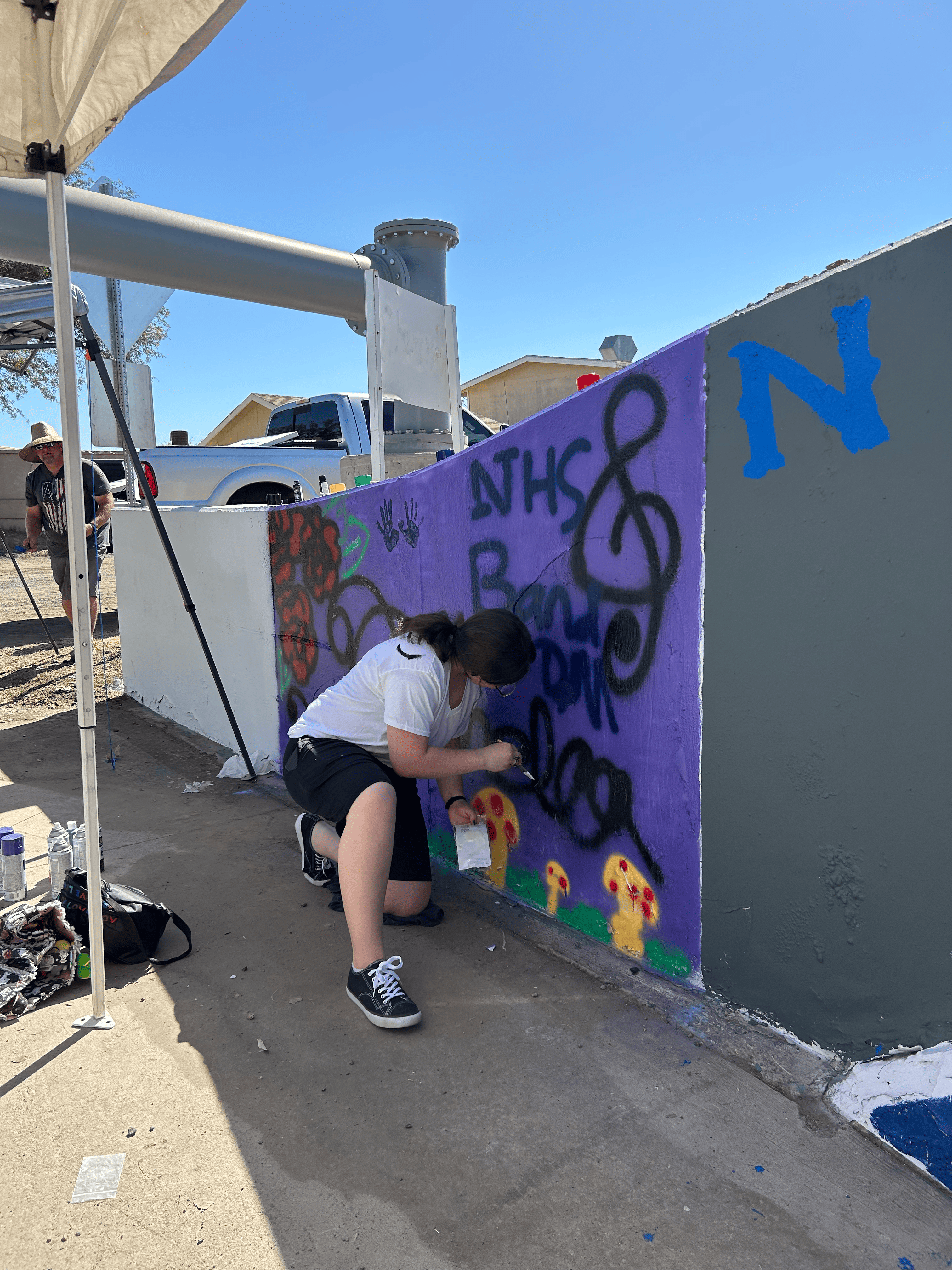 Students painting underpass.