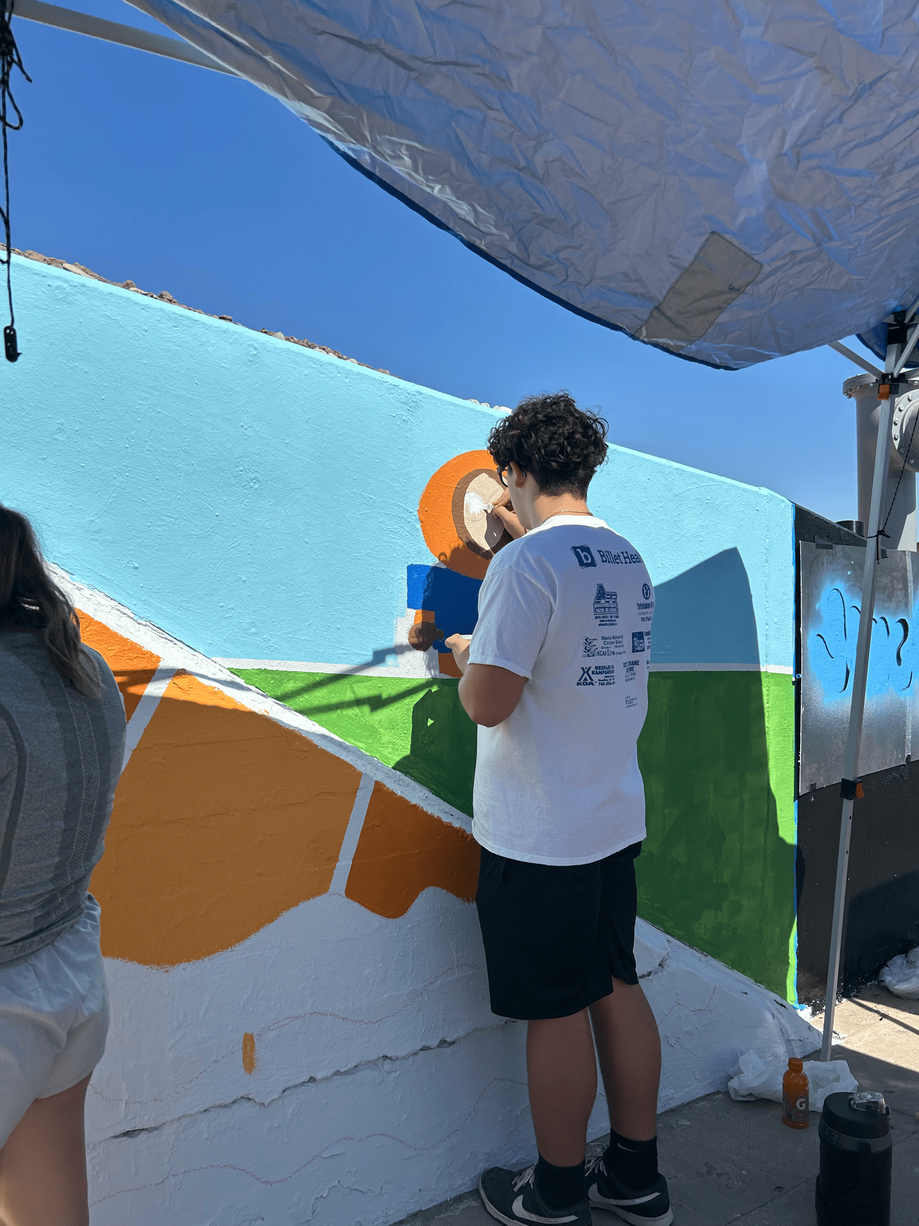 Students painting underpass.