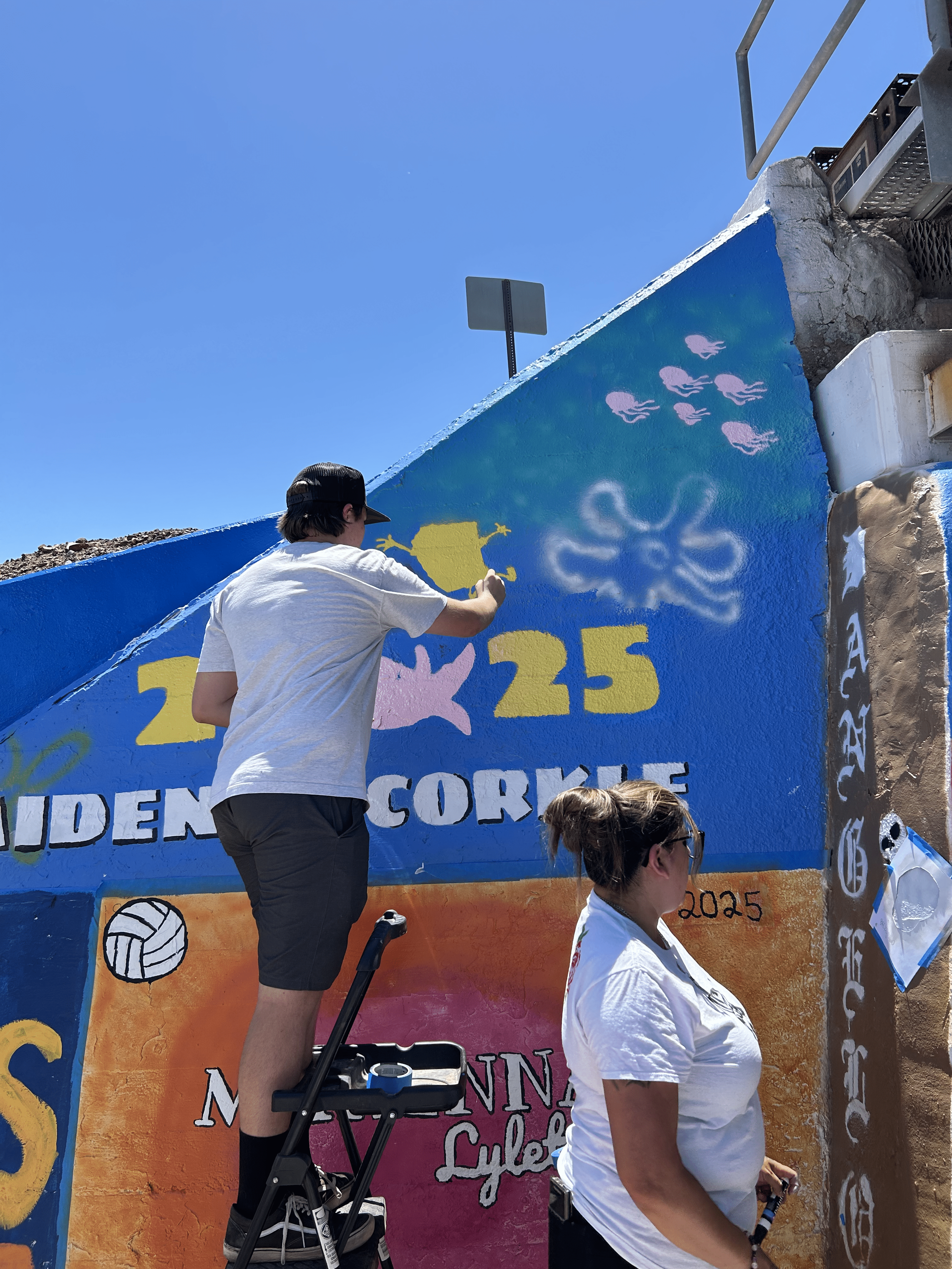 Students painting underpass.