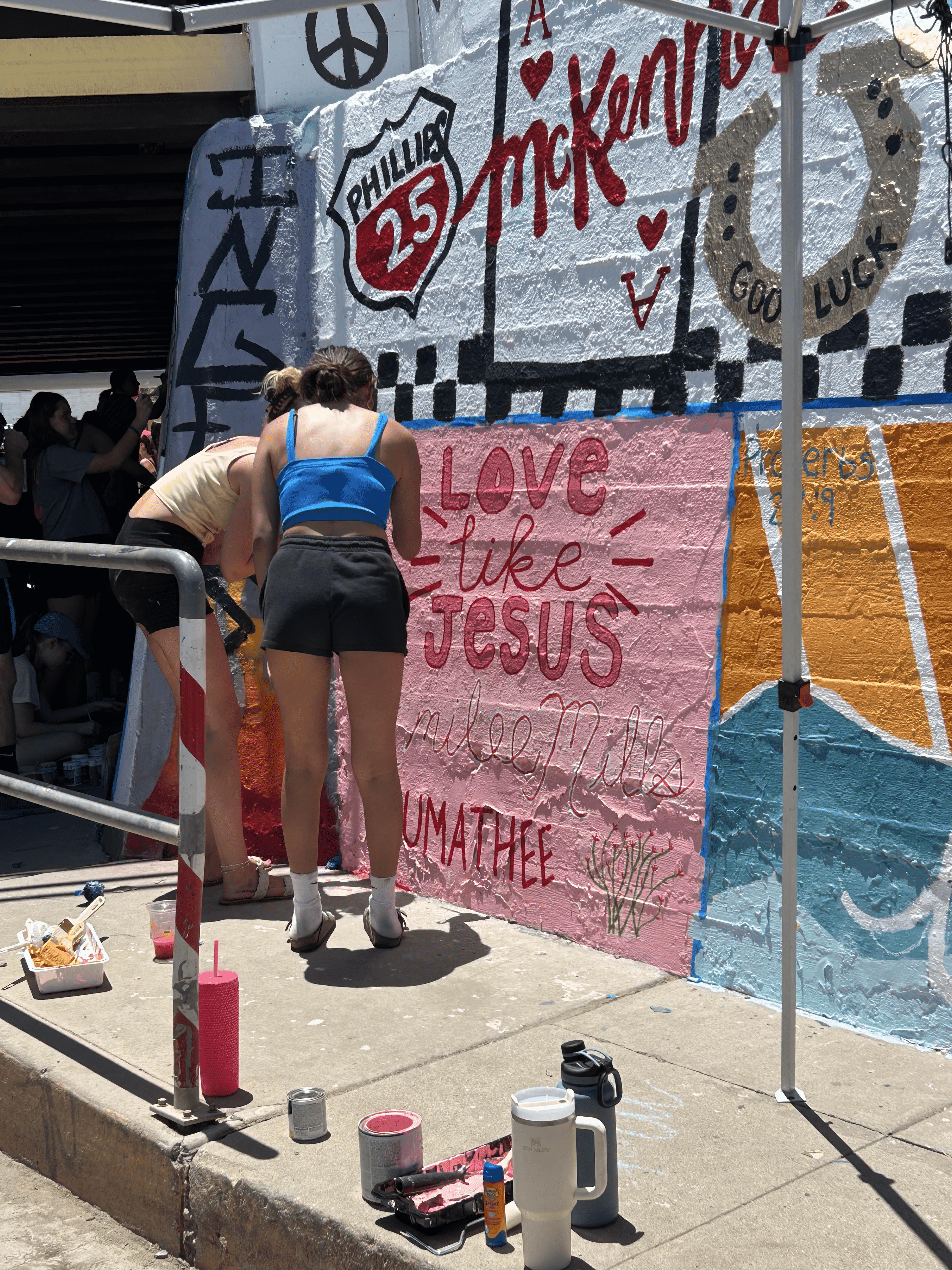 Students painting underpass.