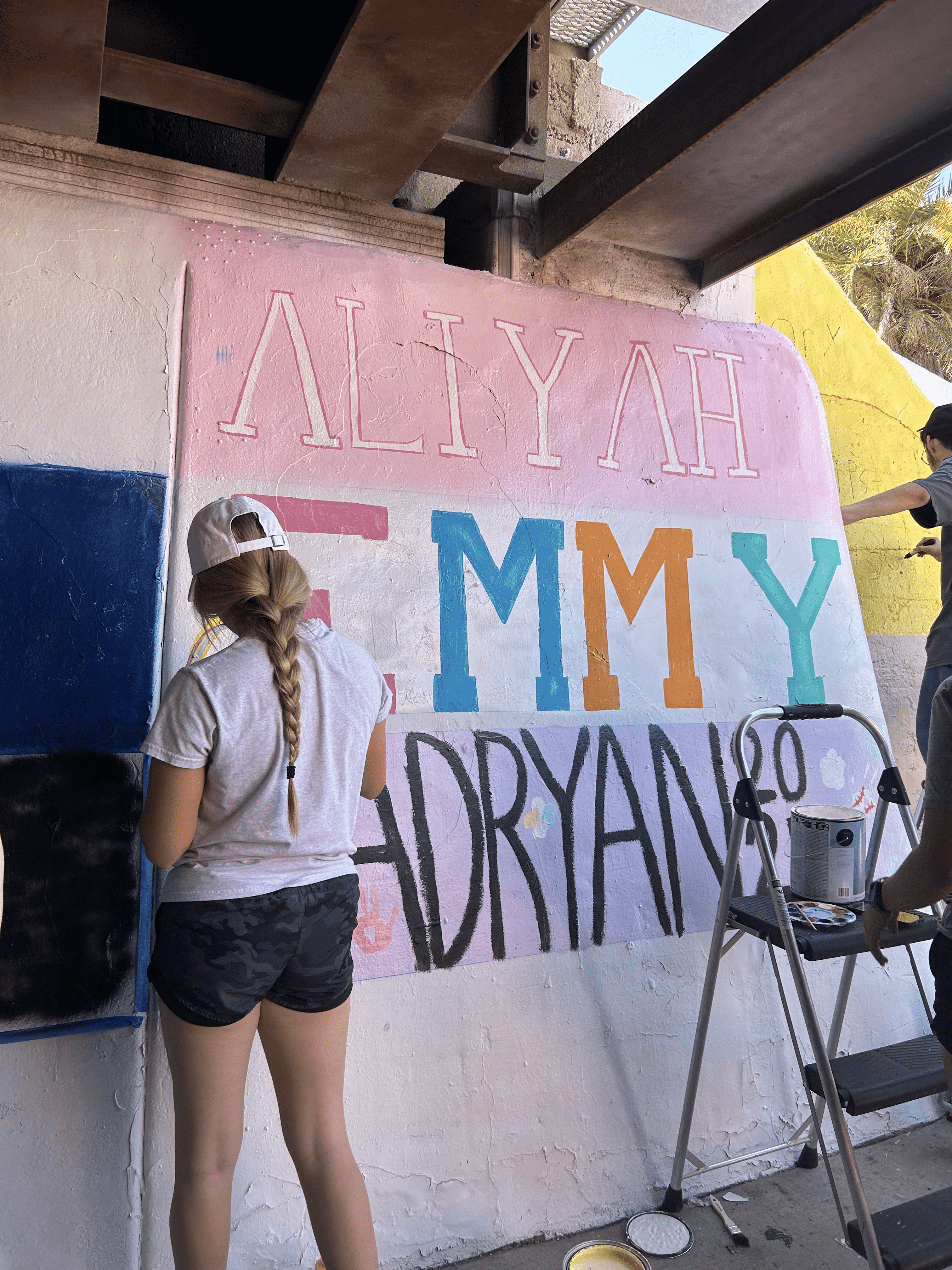 Students painting underpass.