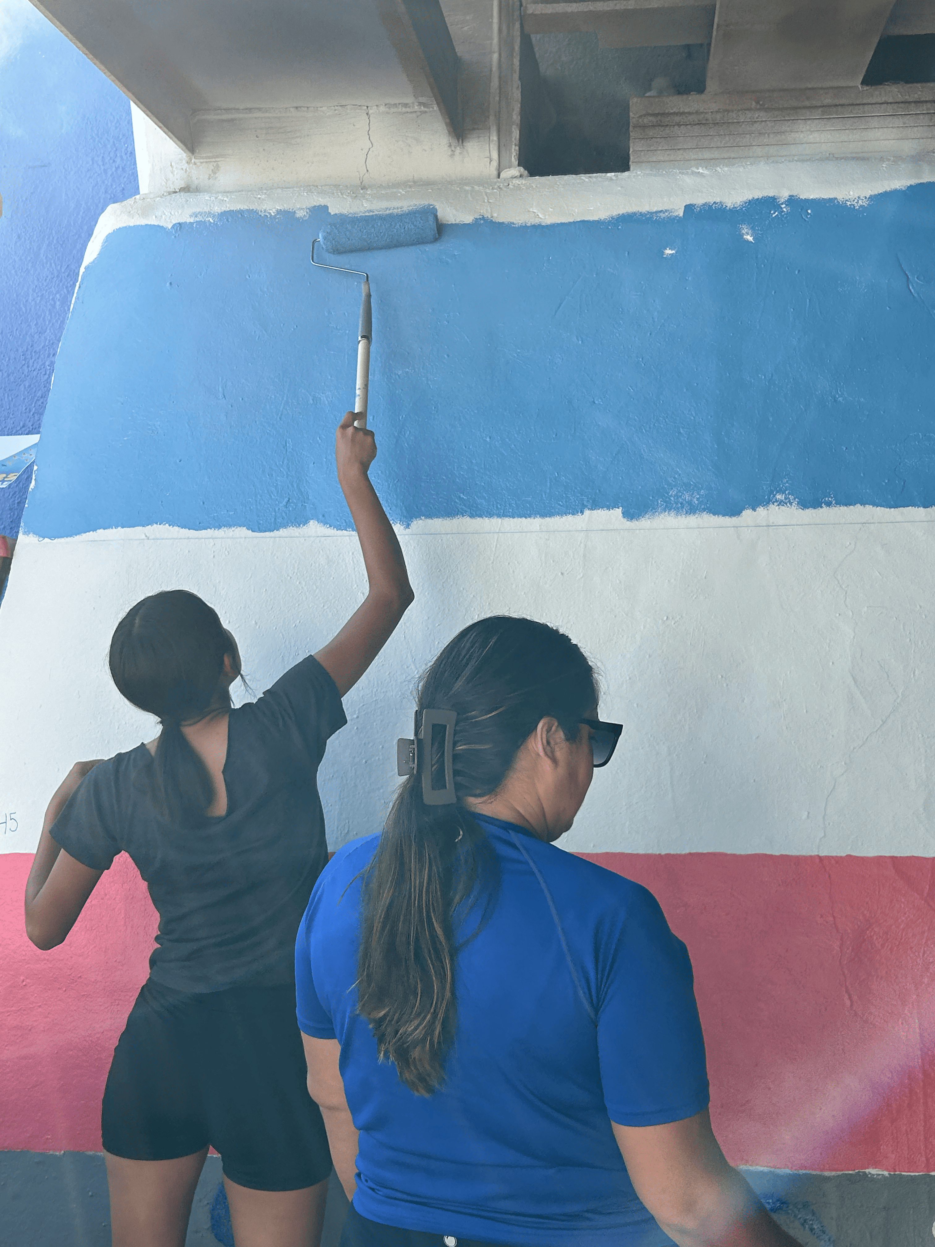 Students painting underpass.