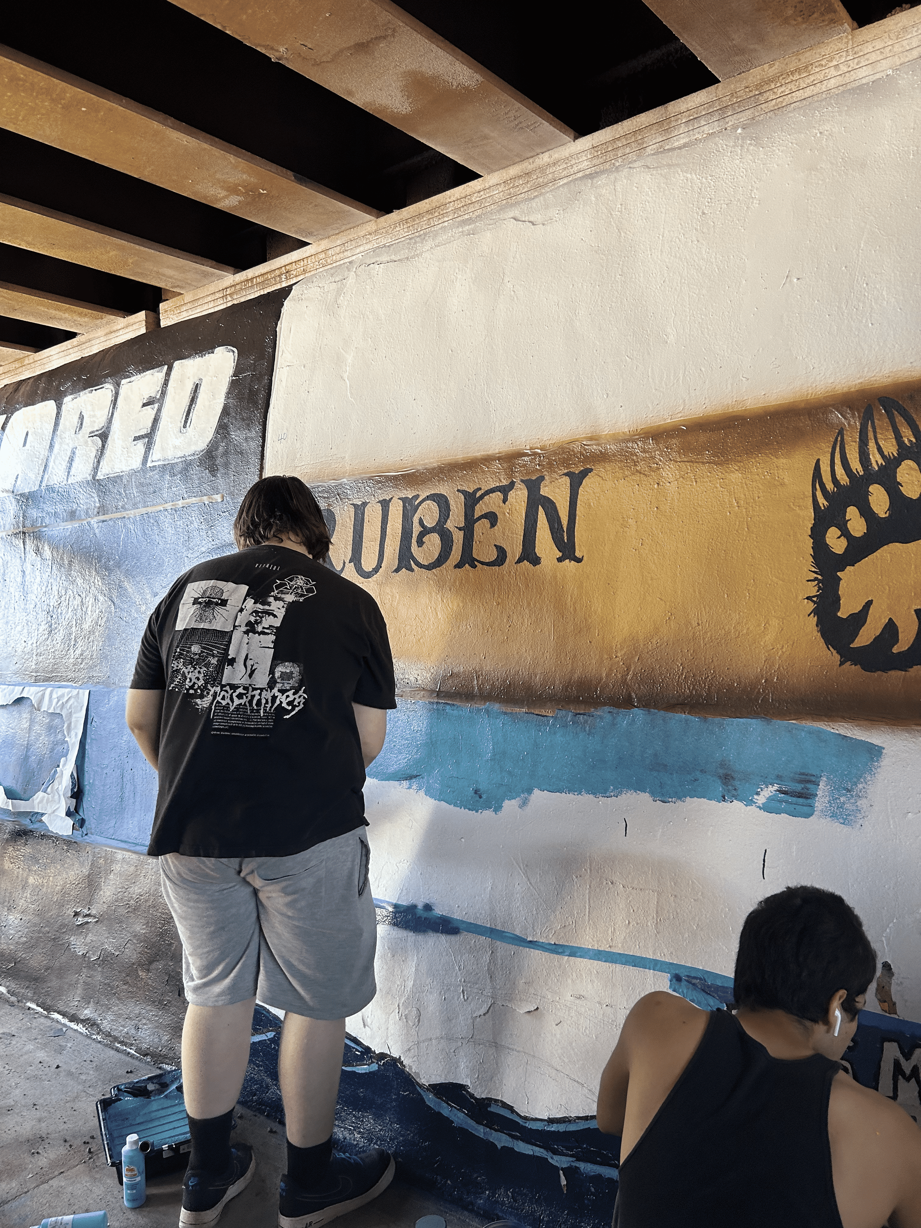 Students painting underpass.