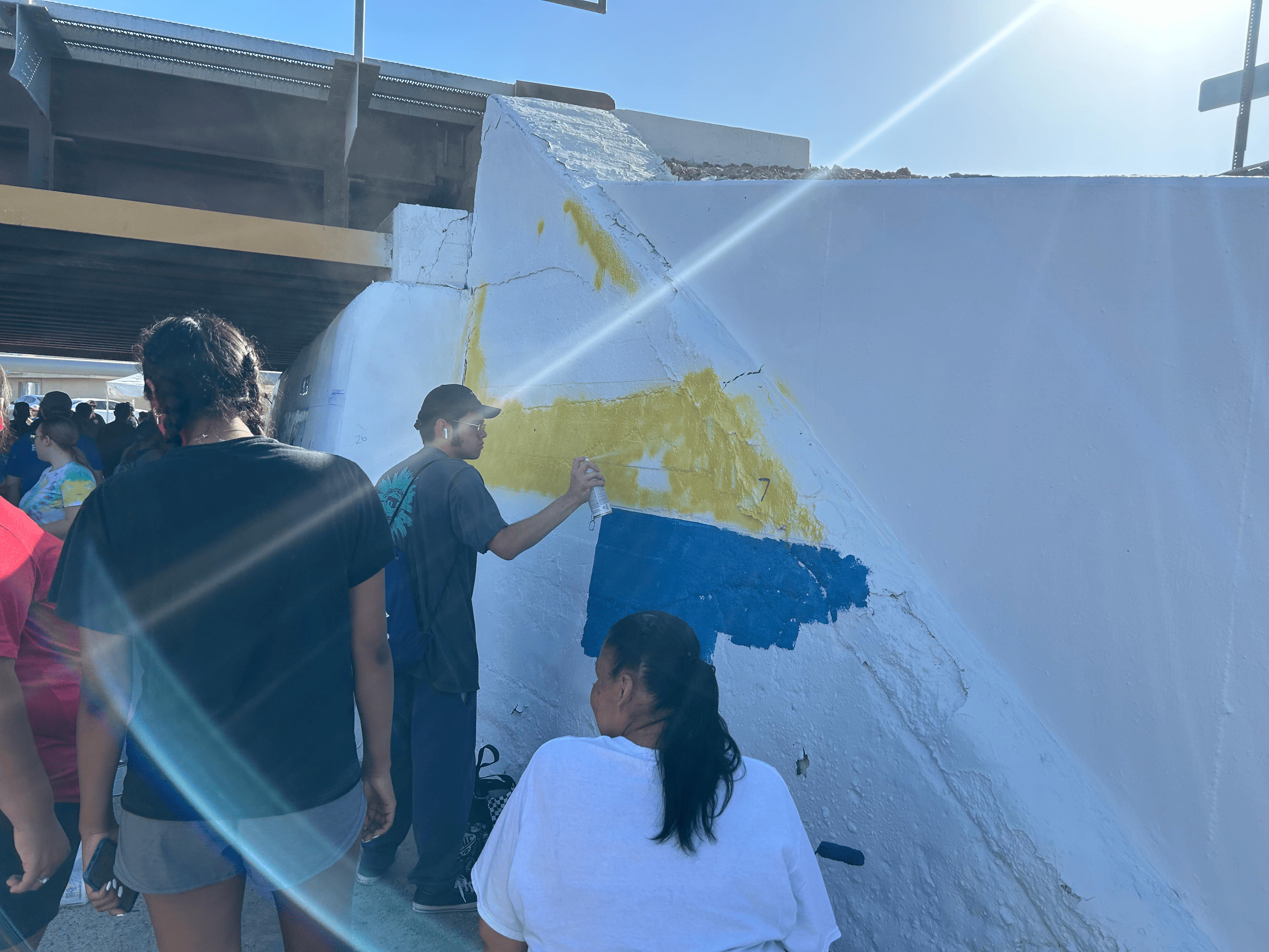 Students painting underpass.