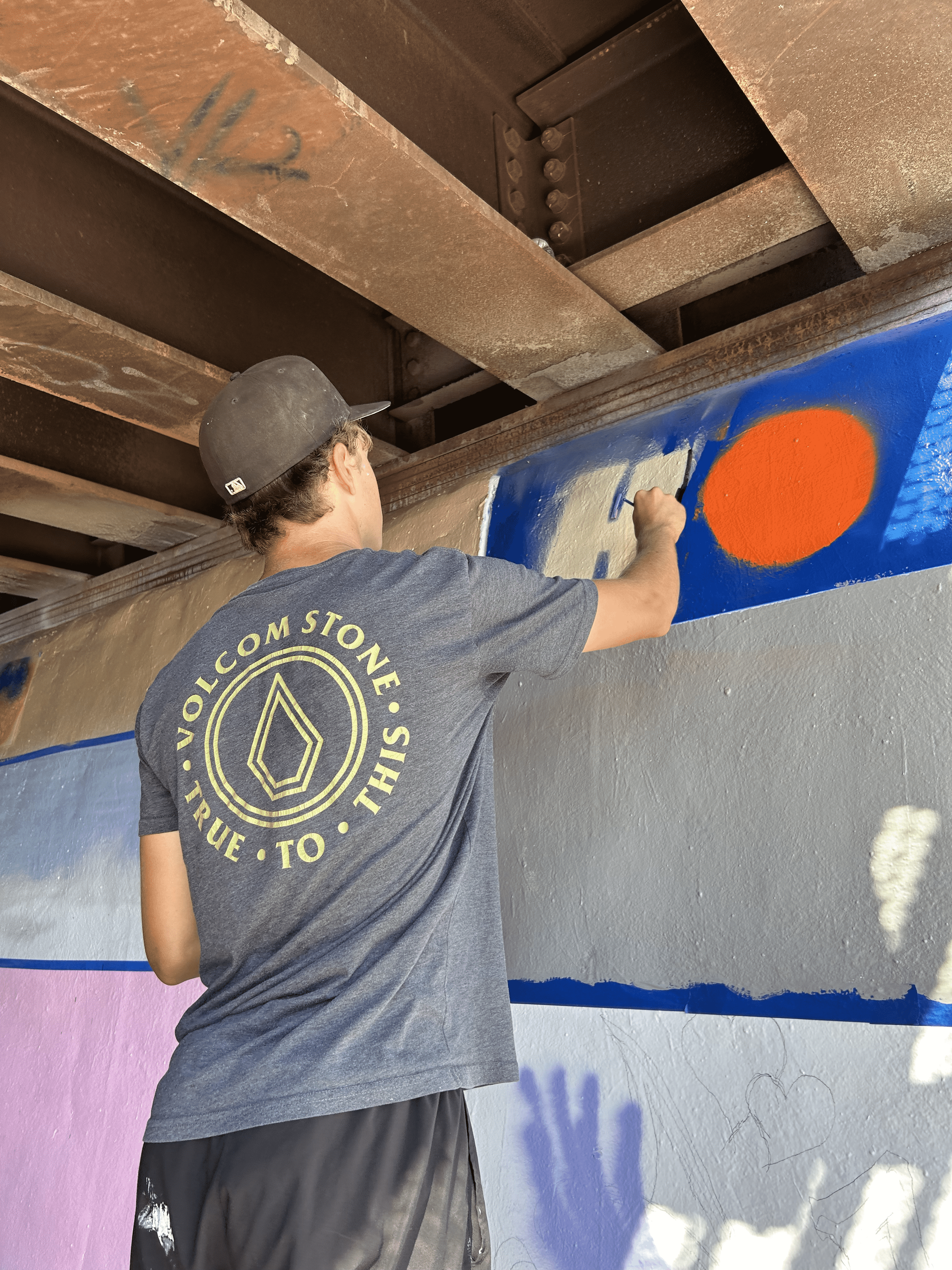 Students painting underpass.