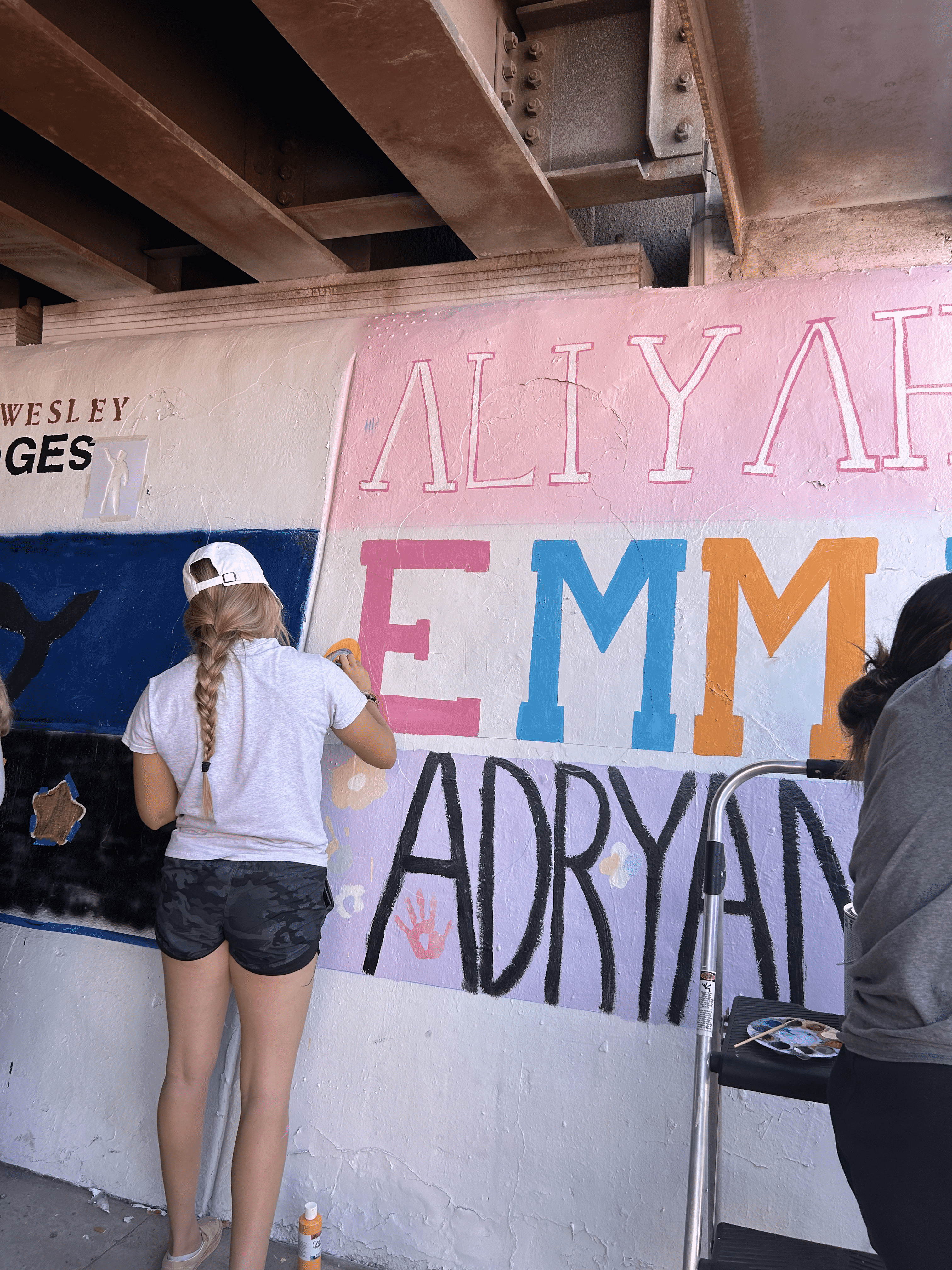 Students painting underpass.