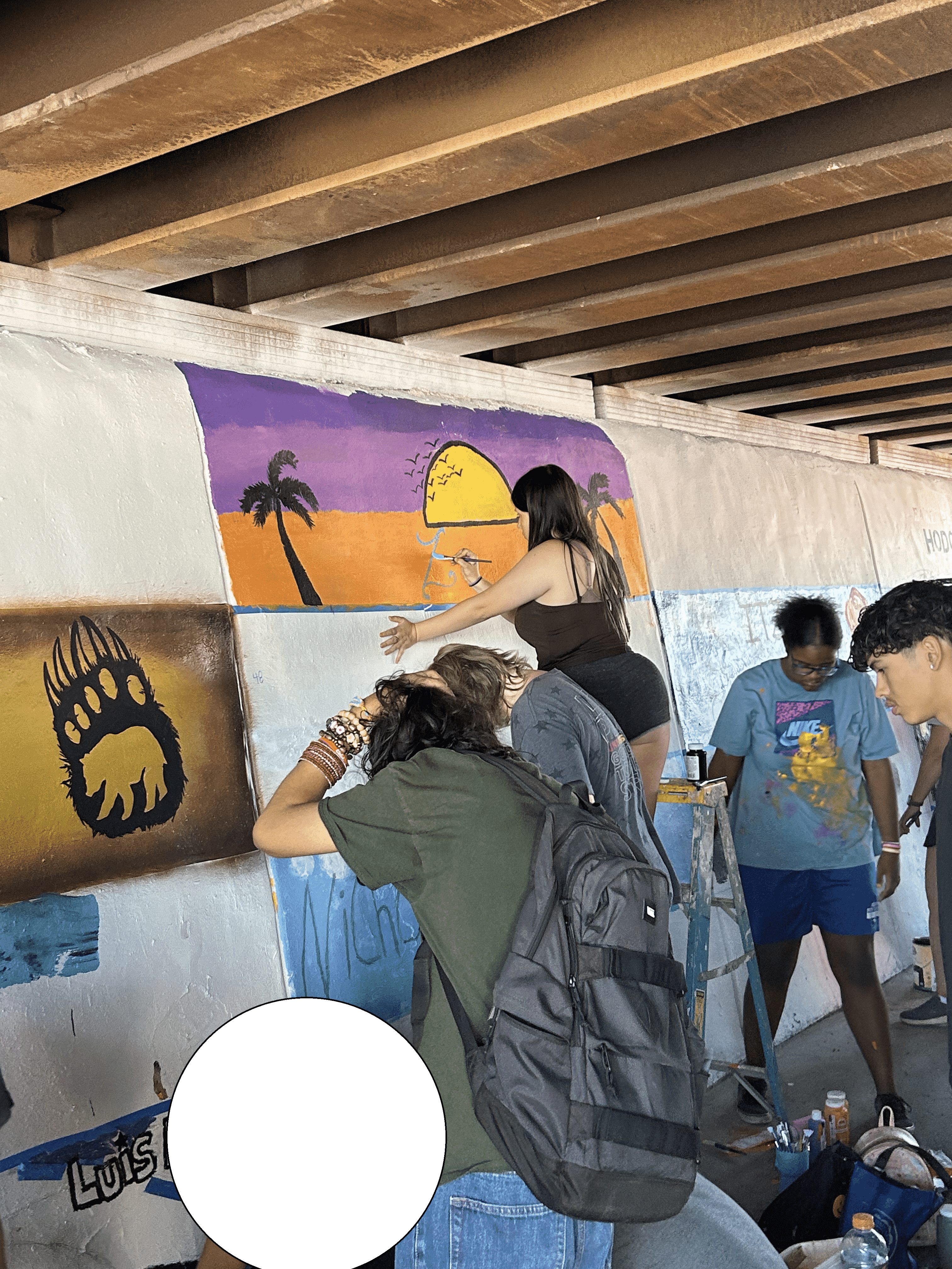 Students painting underpass.