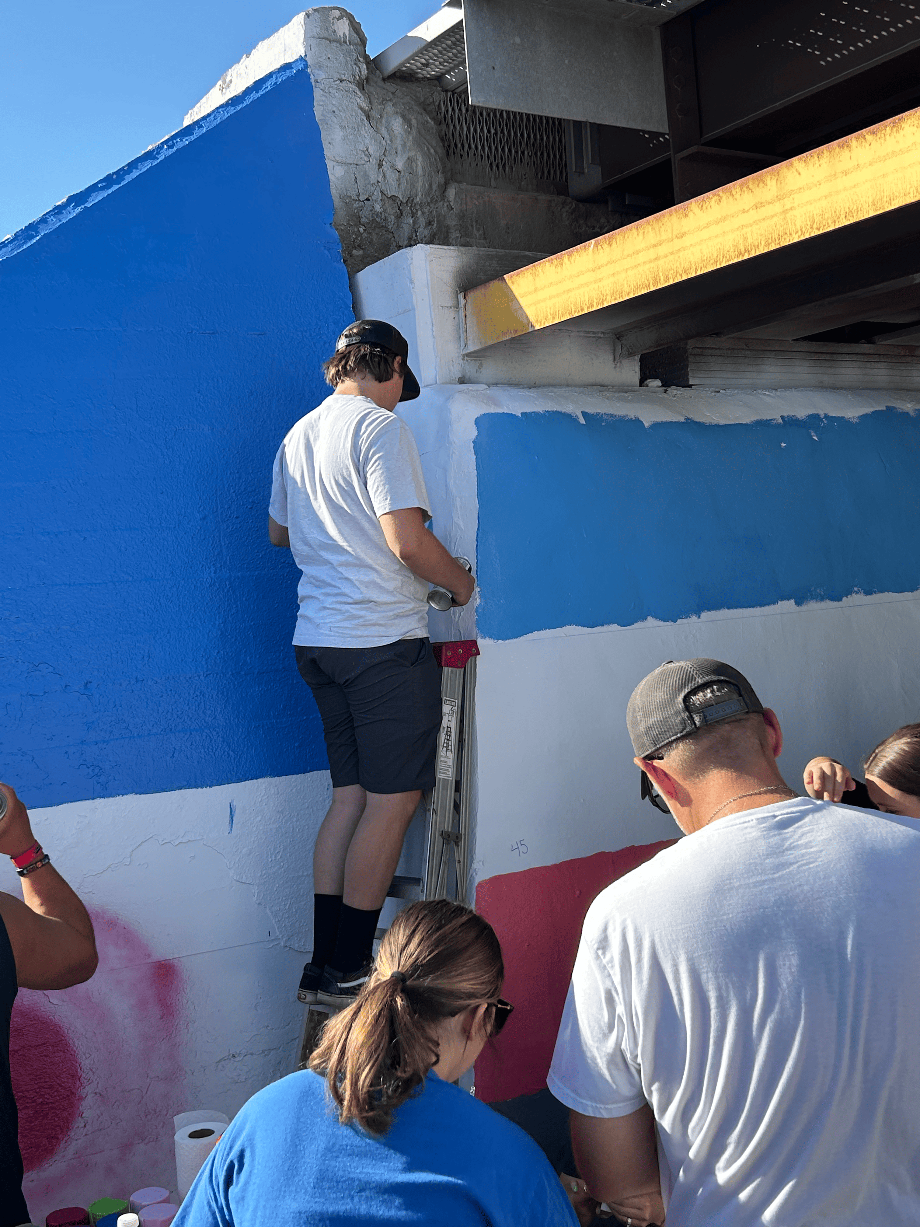 Students painting underpass.