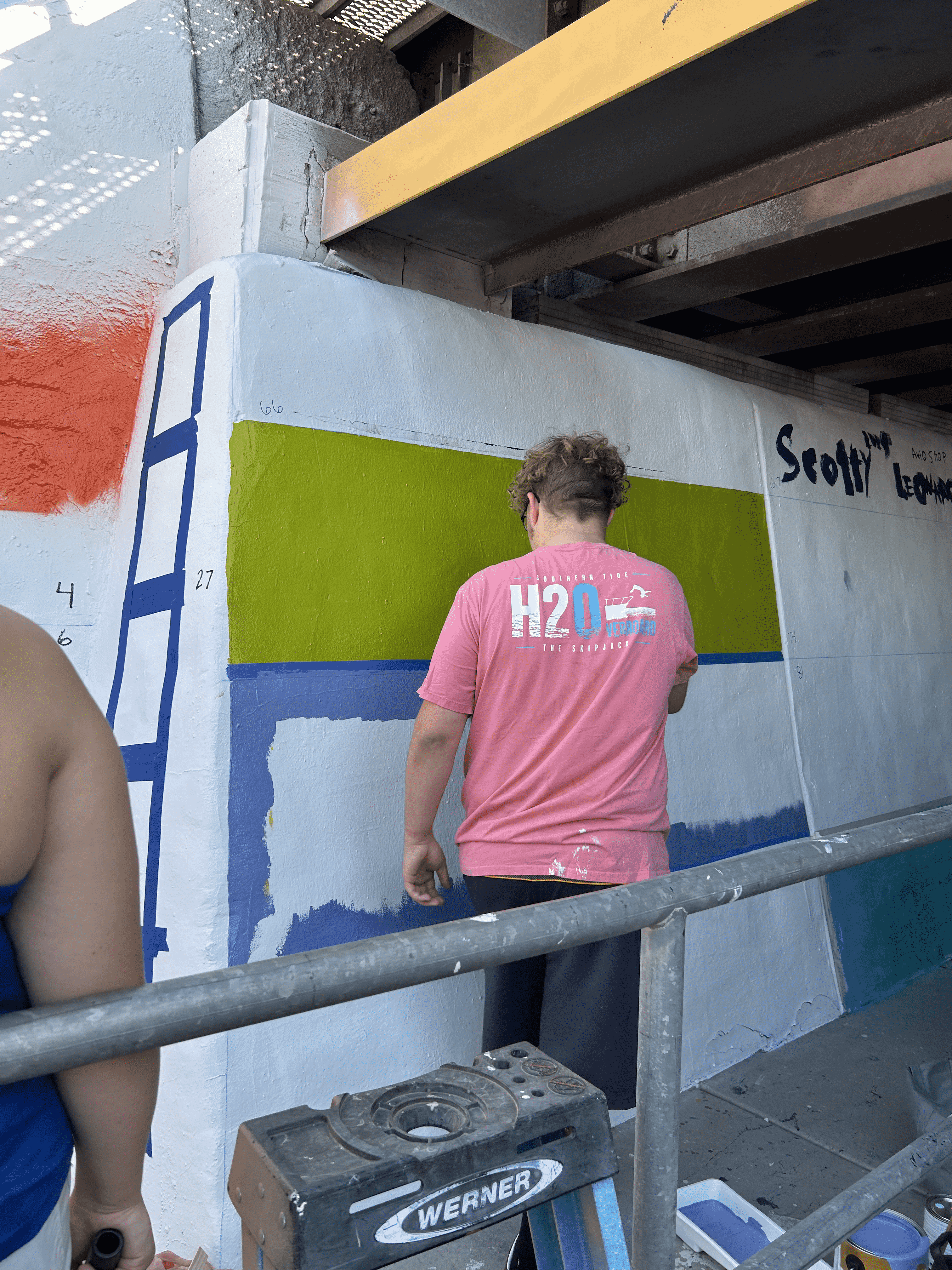 Students painting underpass.