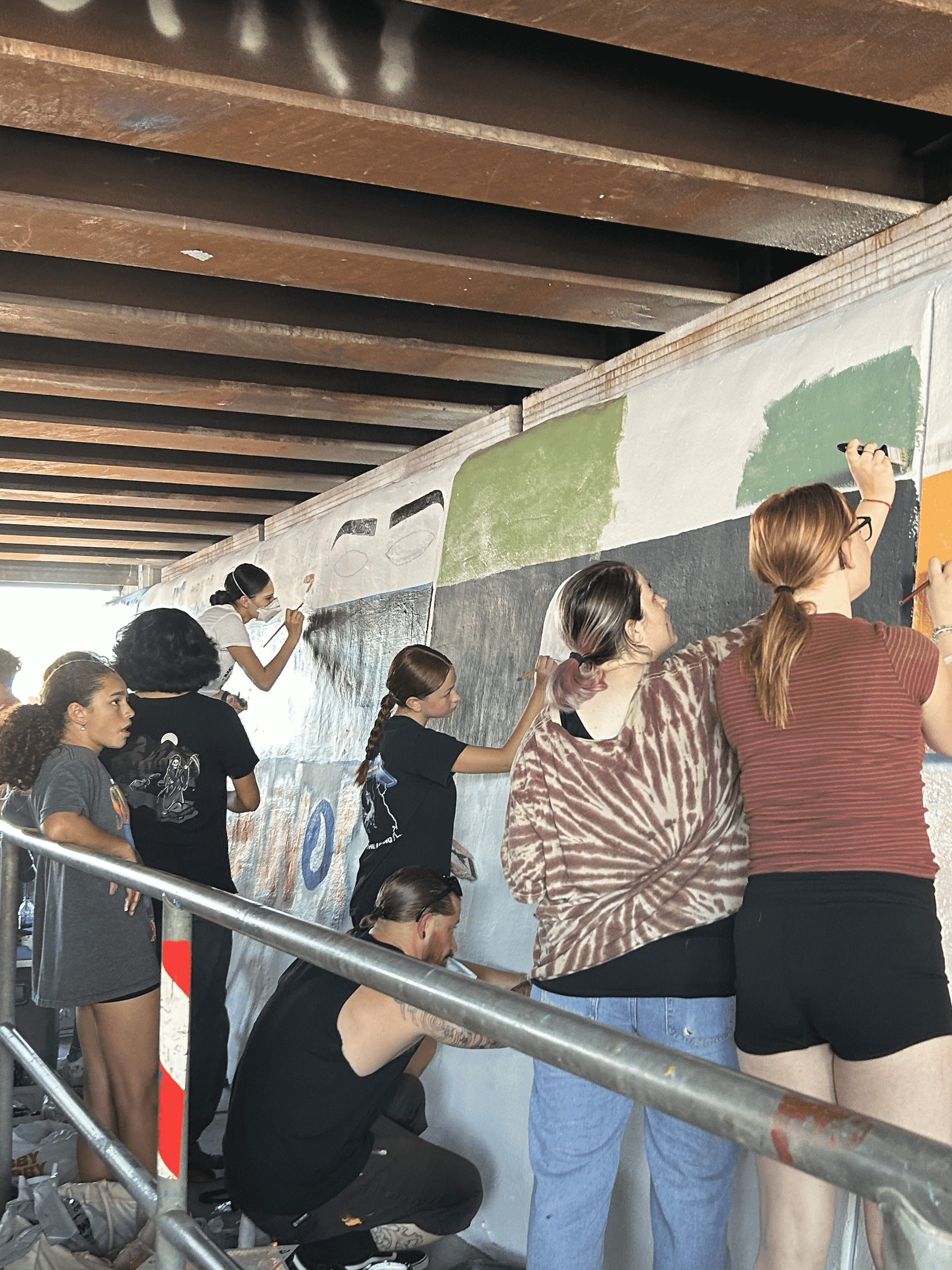 Students painting underpass.