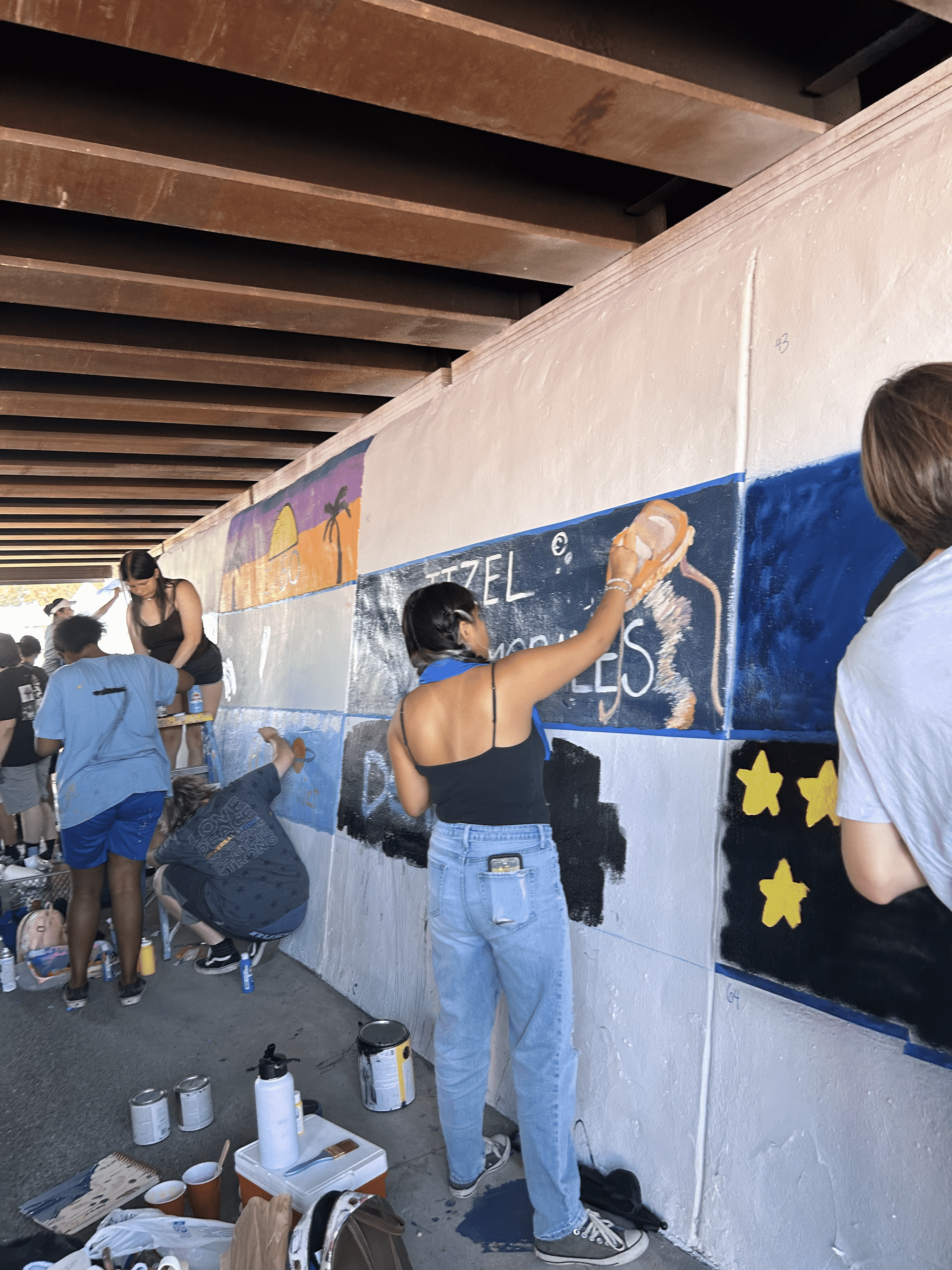 Students painting underpass.