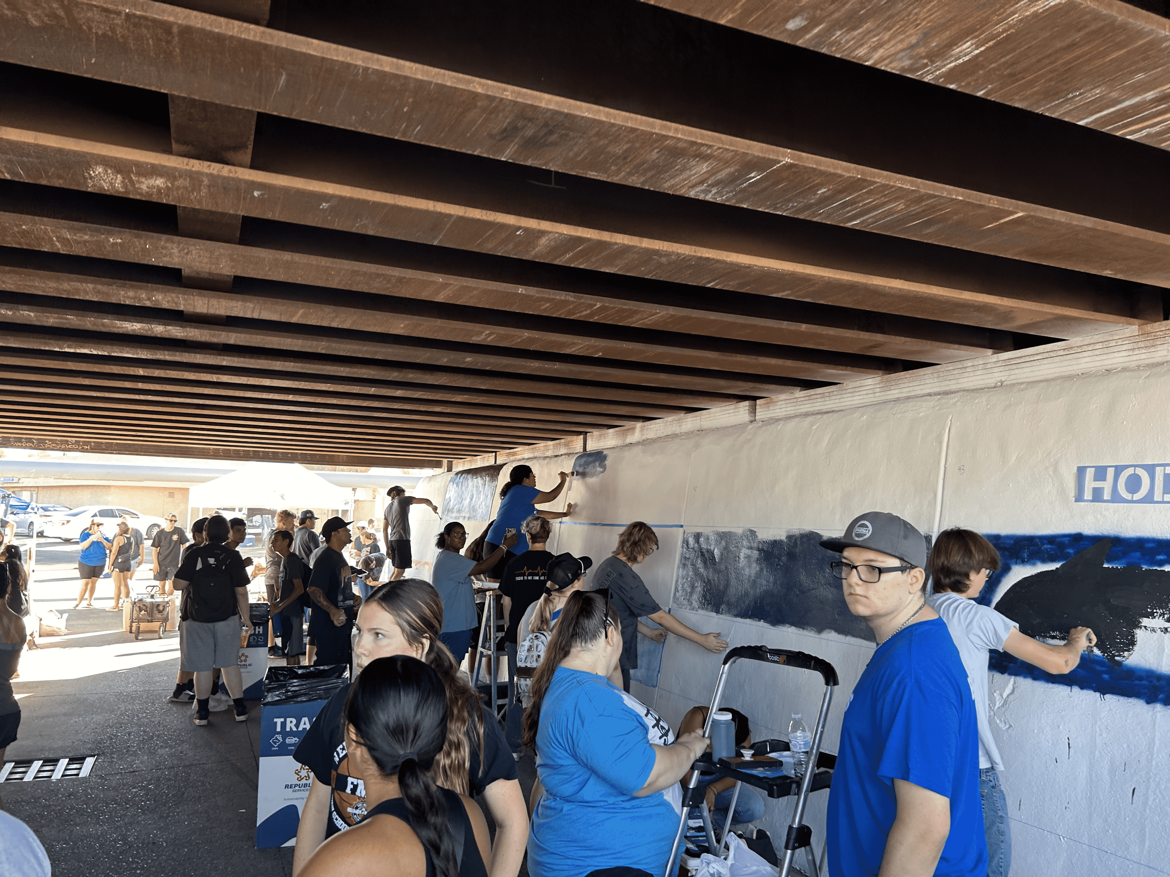 Students painting underpass.