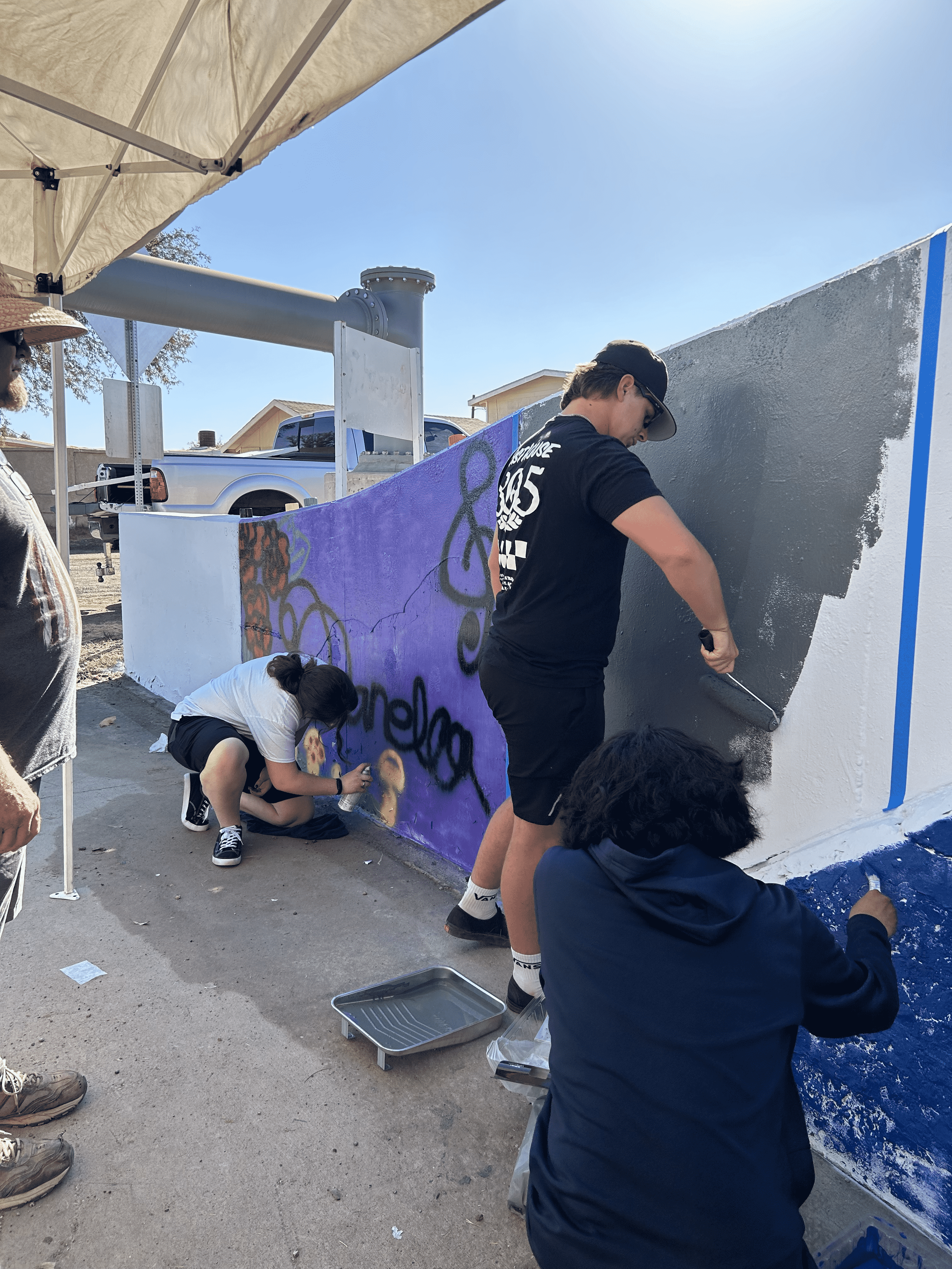 Students painting underpass.