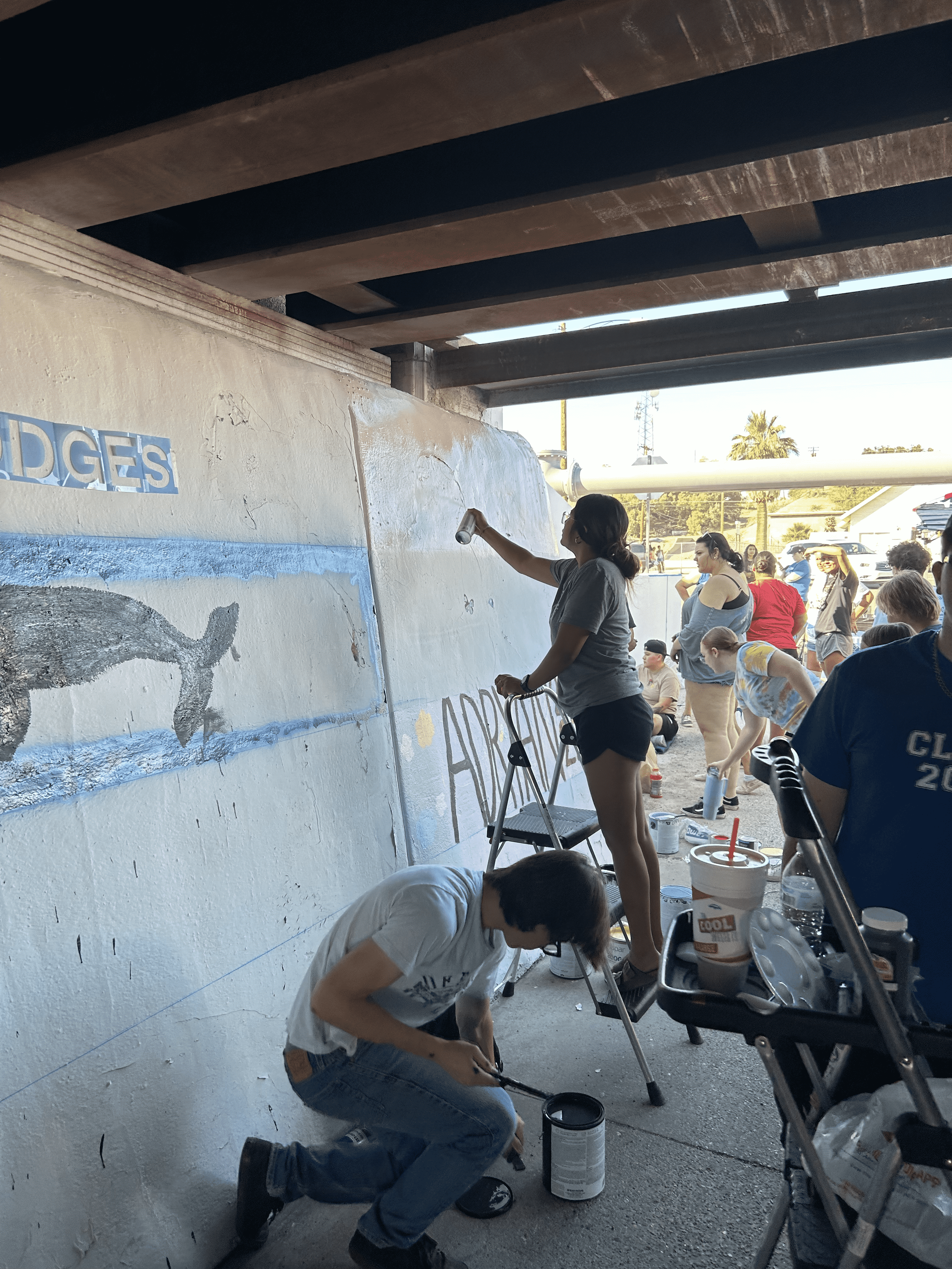 Students painting underpass.