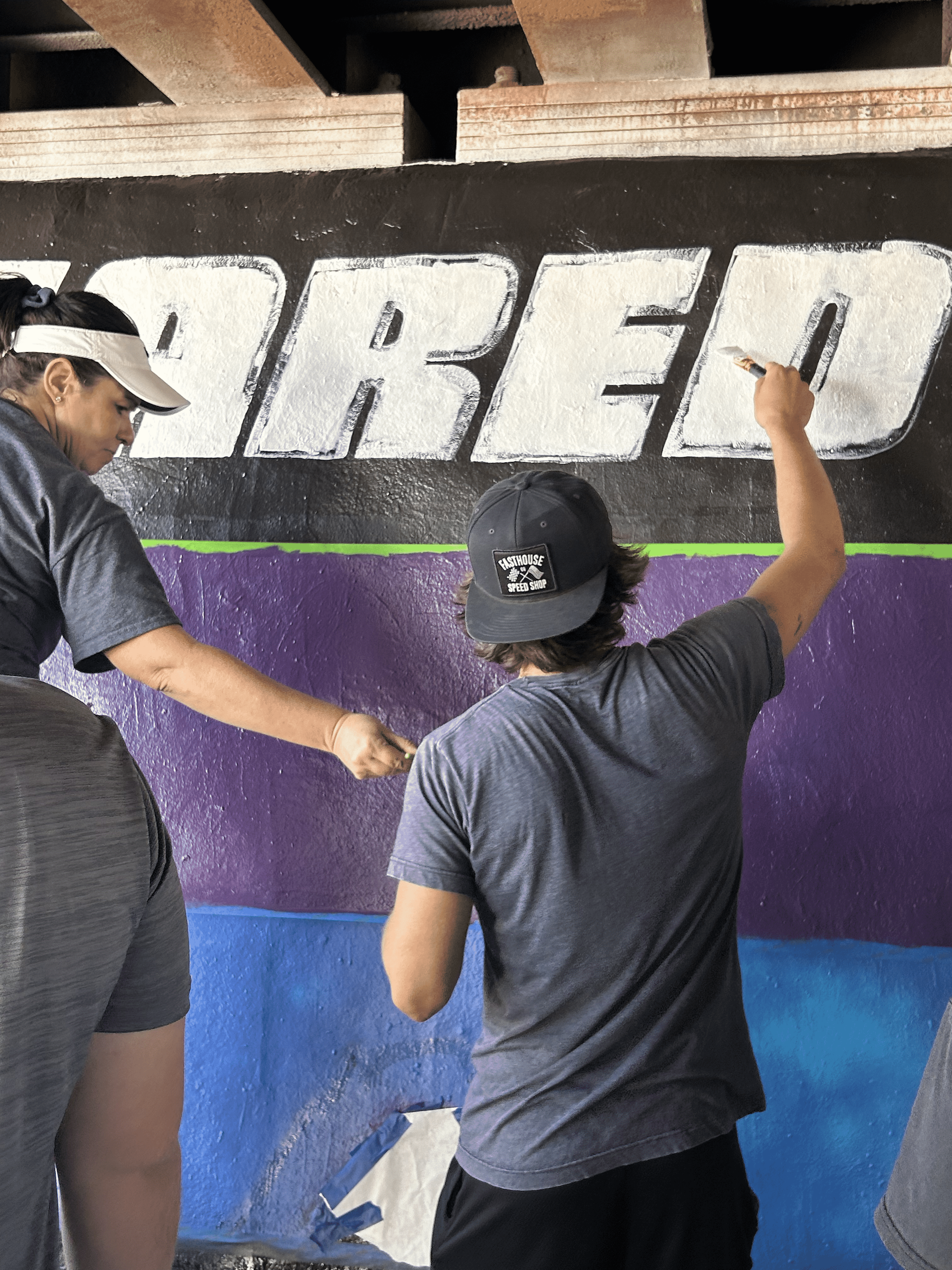 Students painting underpass.