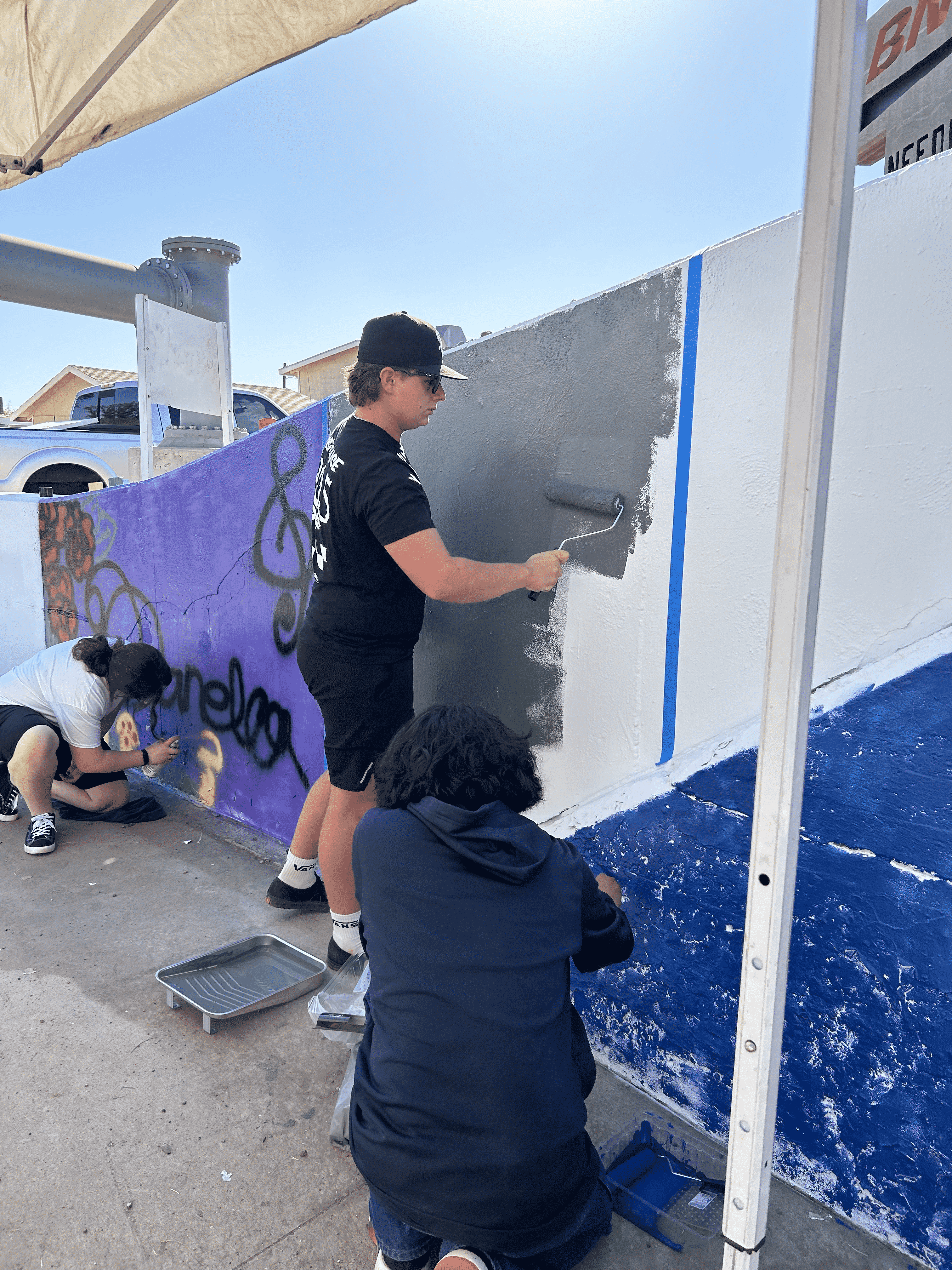 Students painting underpass.