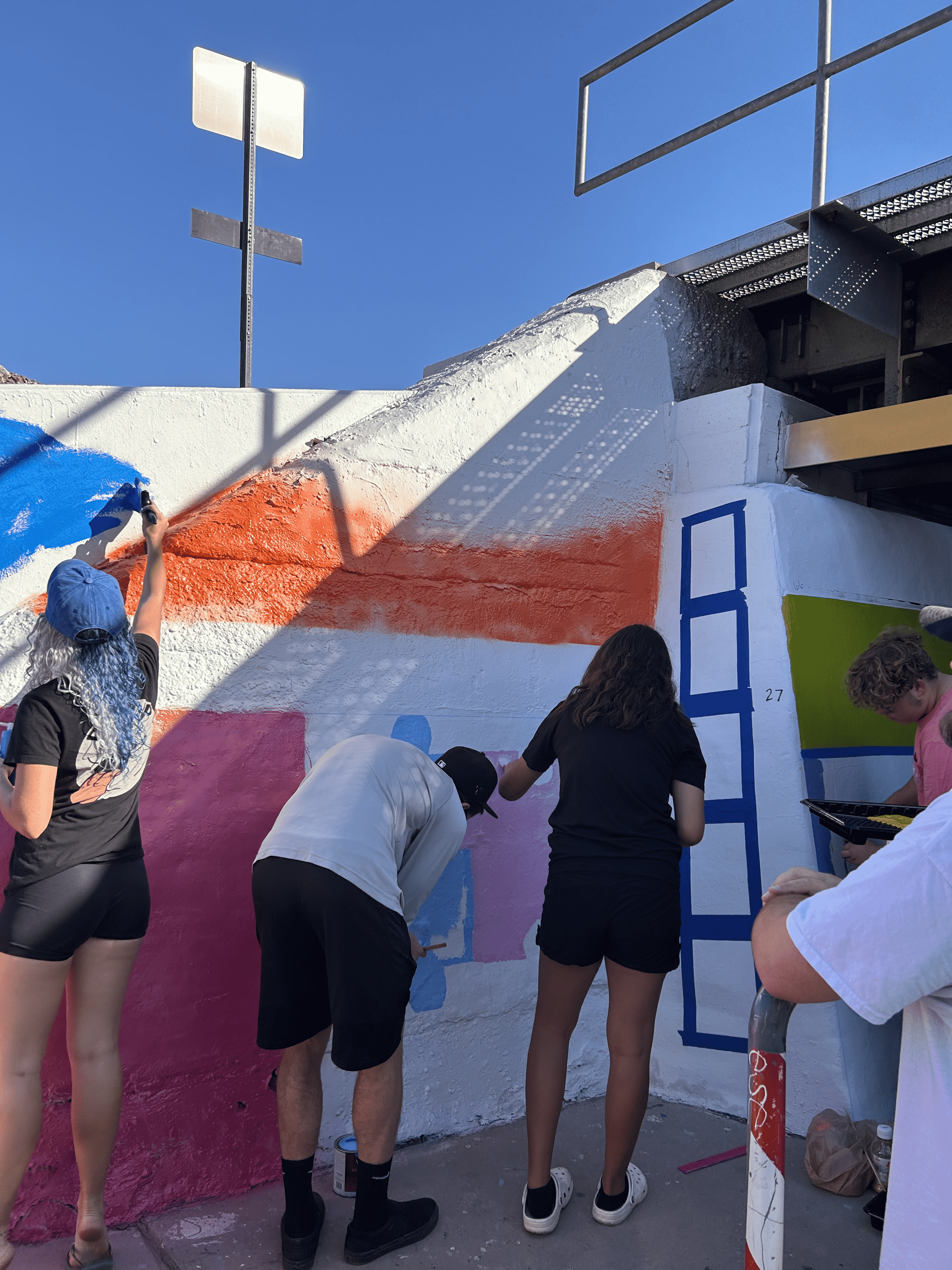 Students painting underpass.