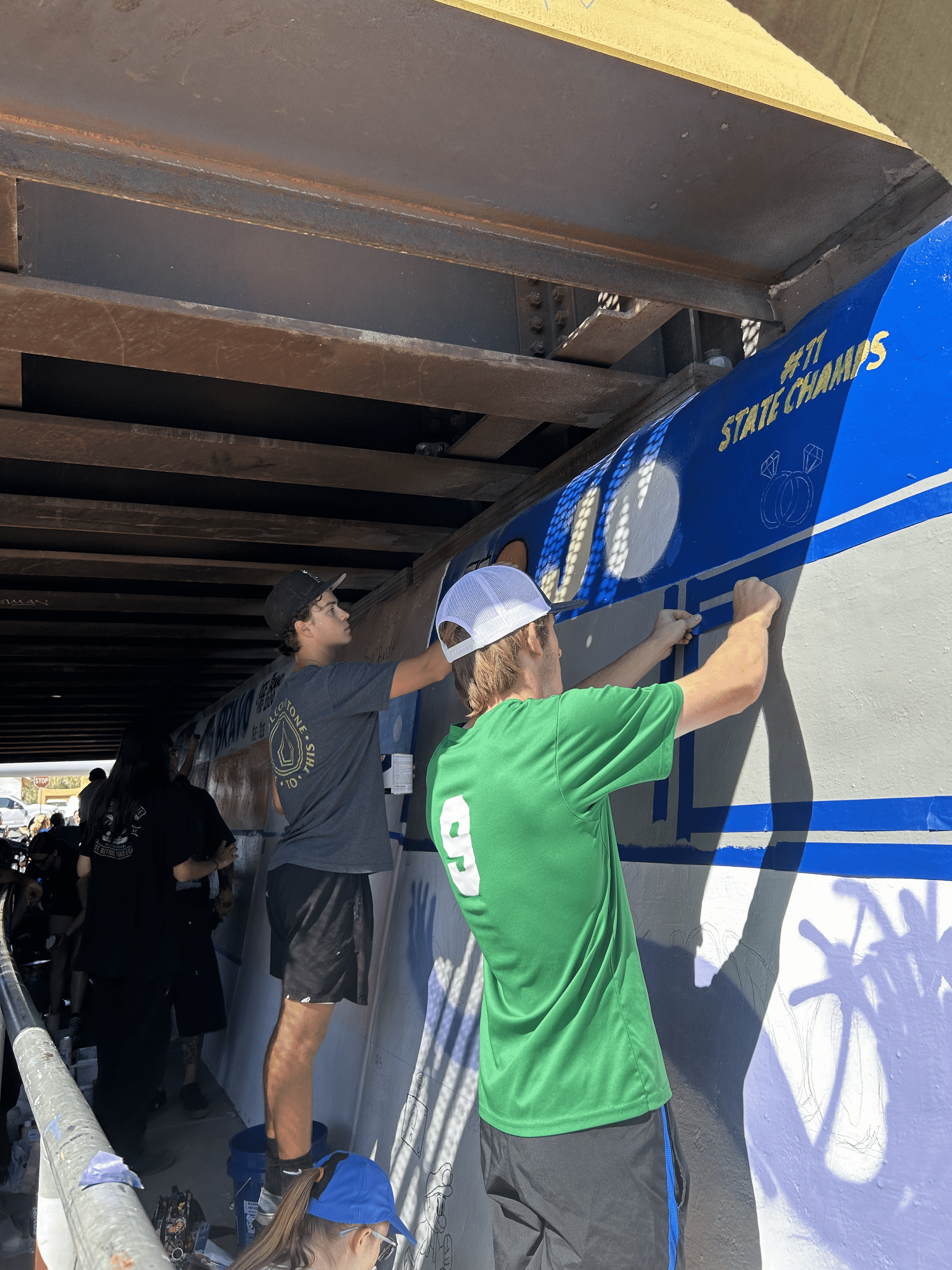 Students painting underpass.