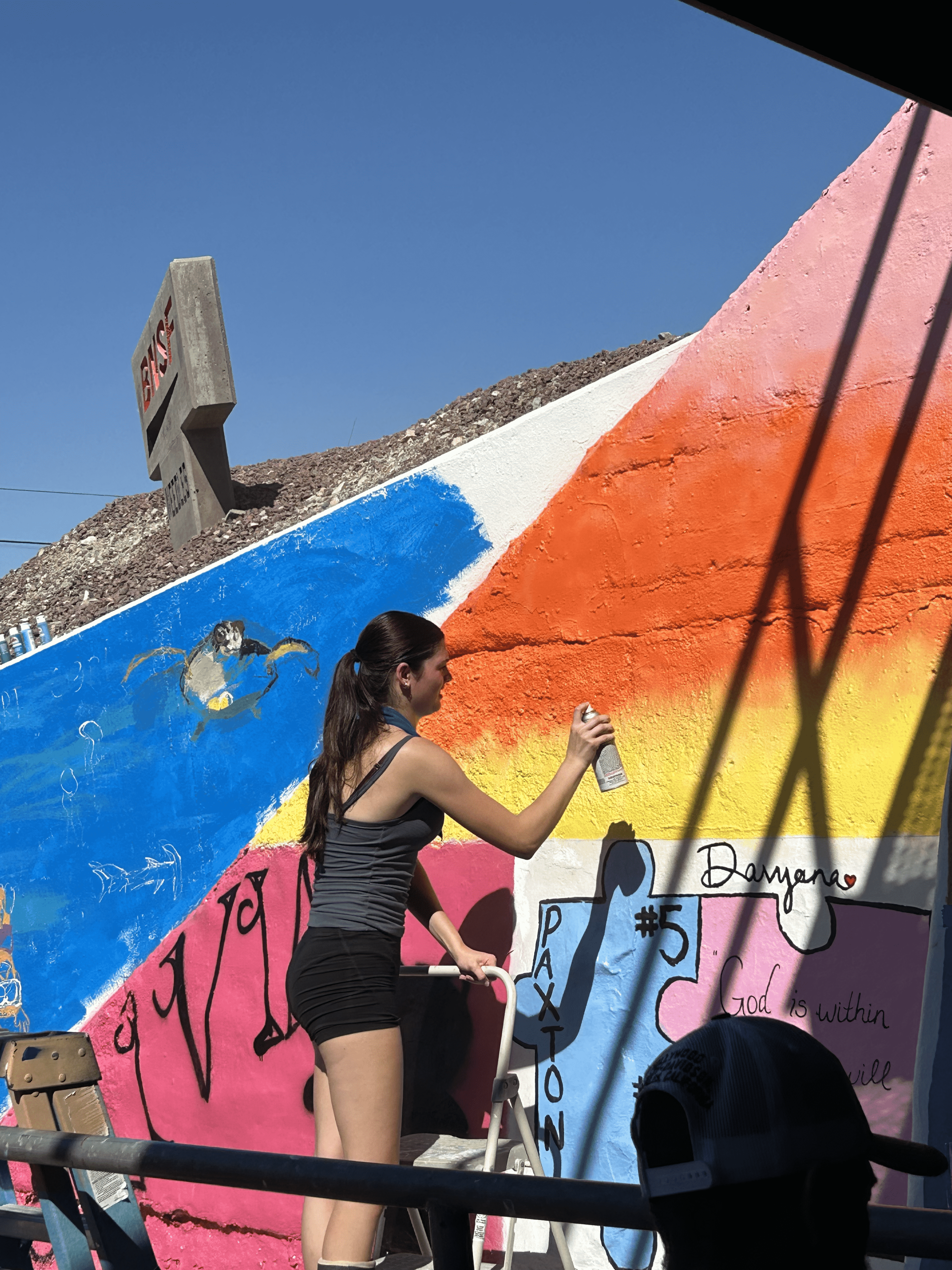 Students painting underpass.