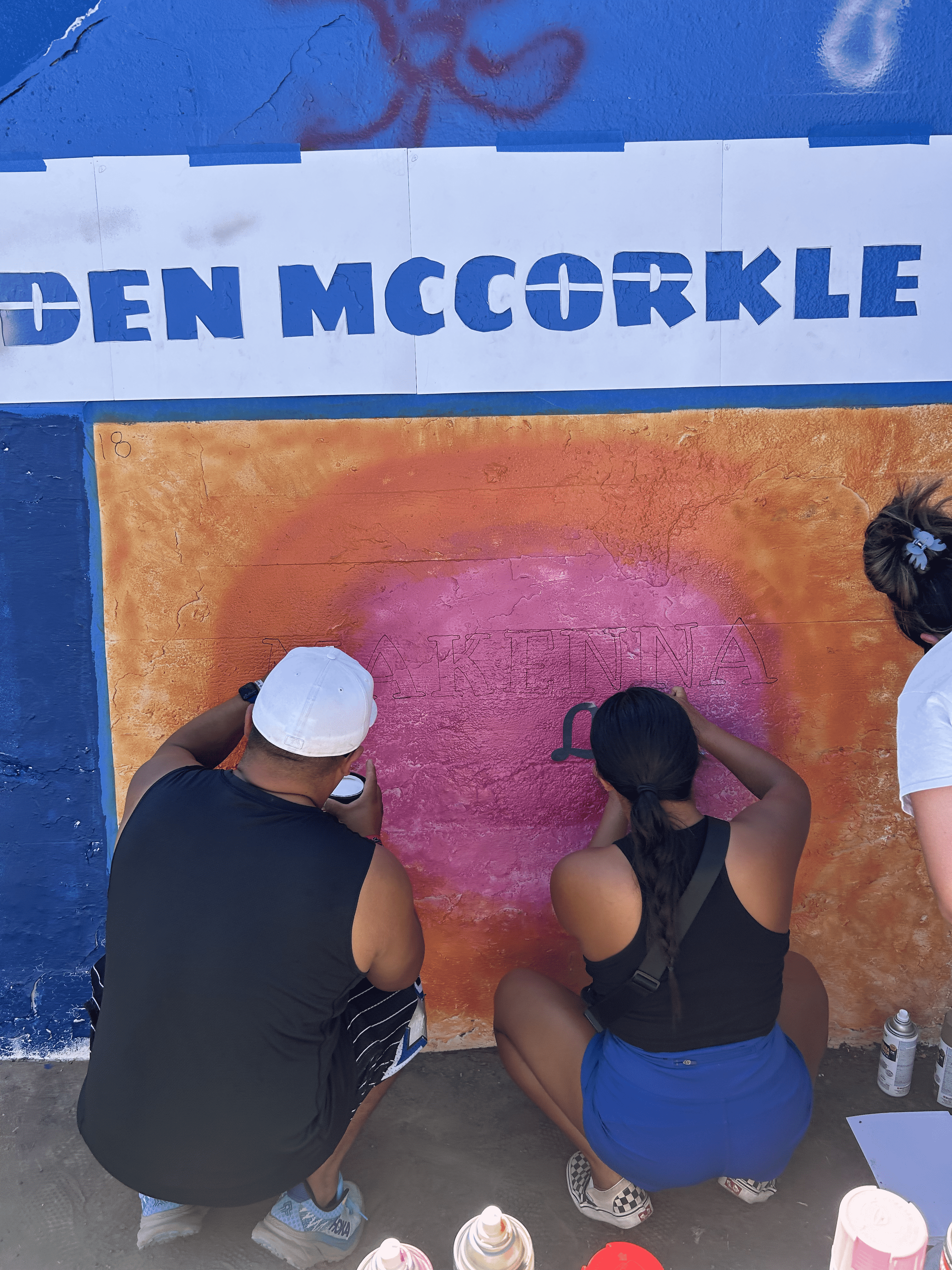 Students painting underpass.