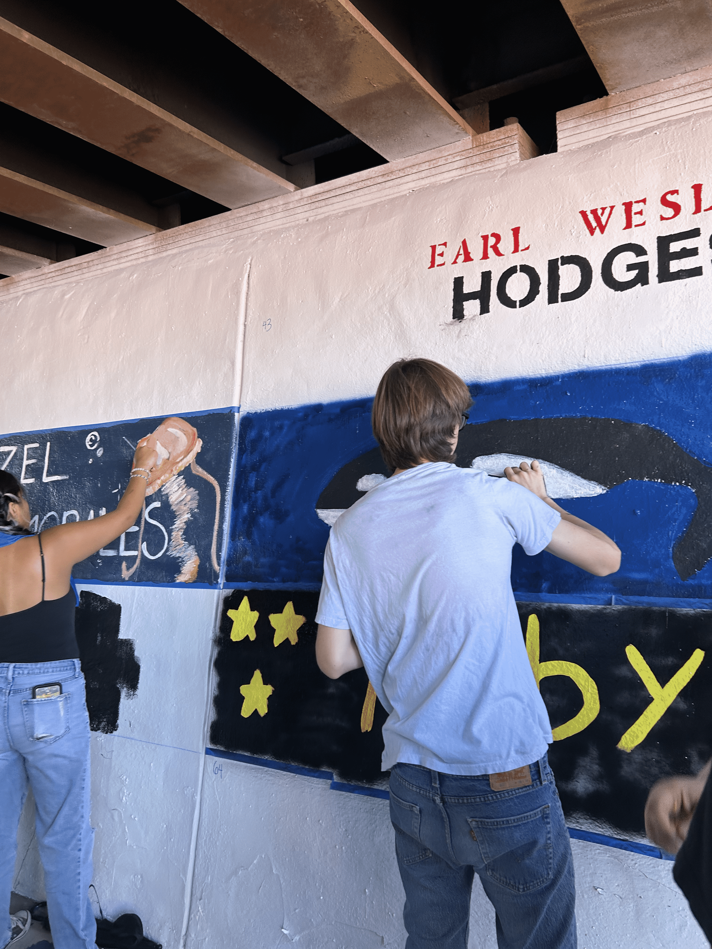 Students painting underpass.