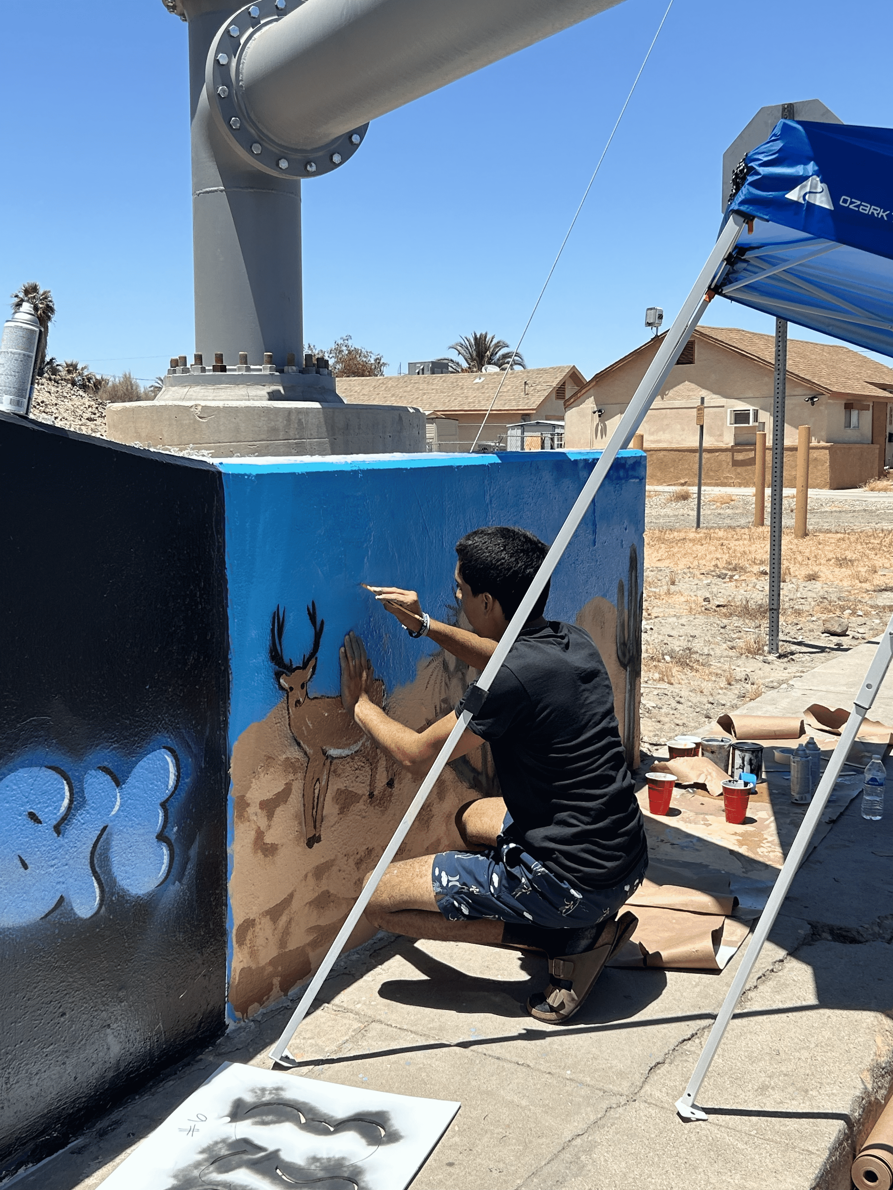 Students painting underpass.