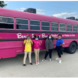 student posing for a picture outside of the bus