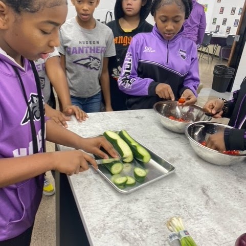 kids cutting cucumber