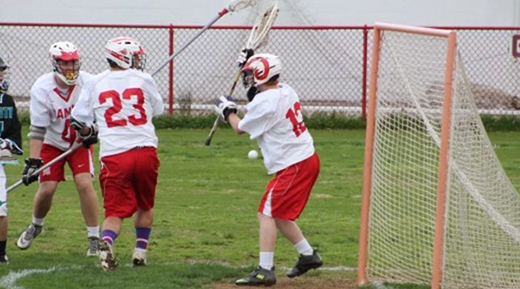 A group of young men playing a game of lacrosse.