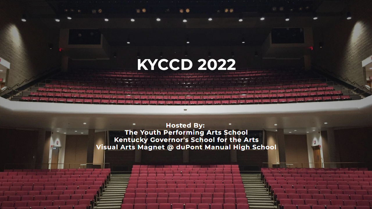 A theatre stage with empty seats and a sign that reads 'KYCD 2022'.