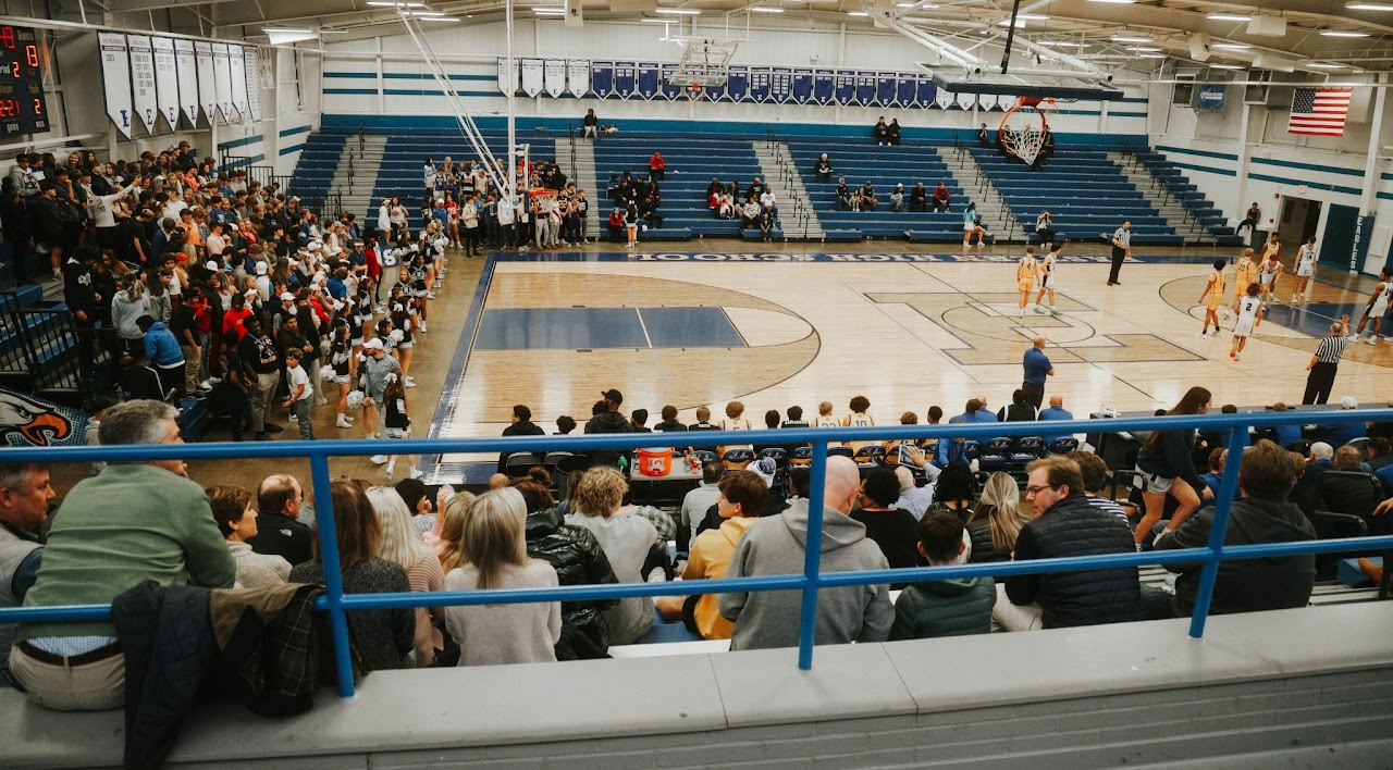 Spectators watching a basketball game from the bleachers.