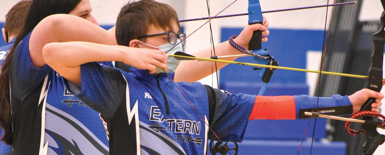 A young archer in action, capturing the essence of competitive sports.