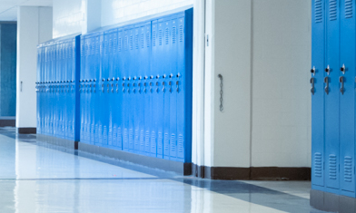 Blue lockers in high school hallway