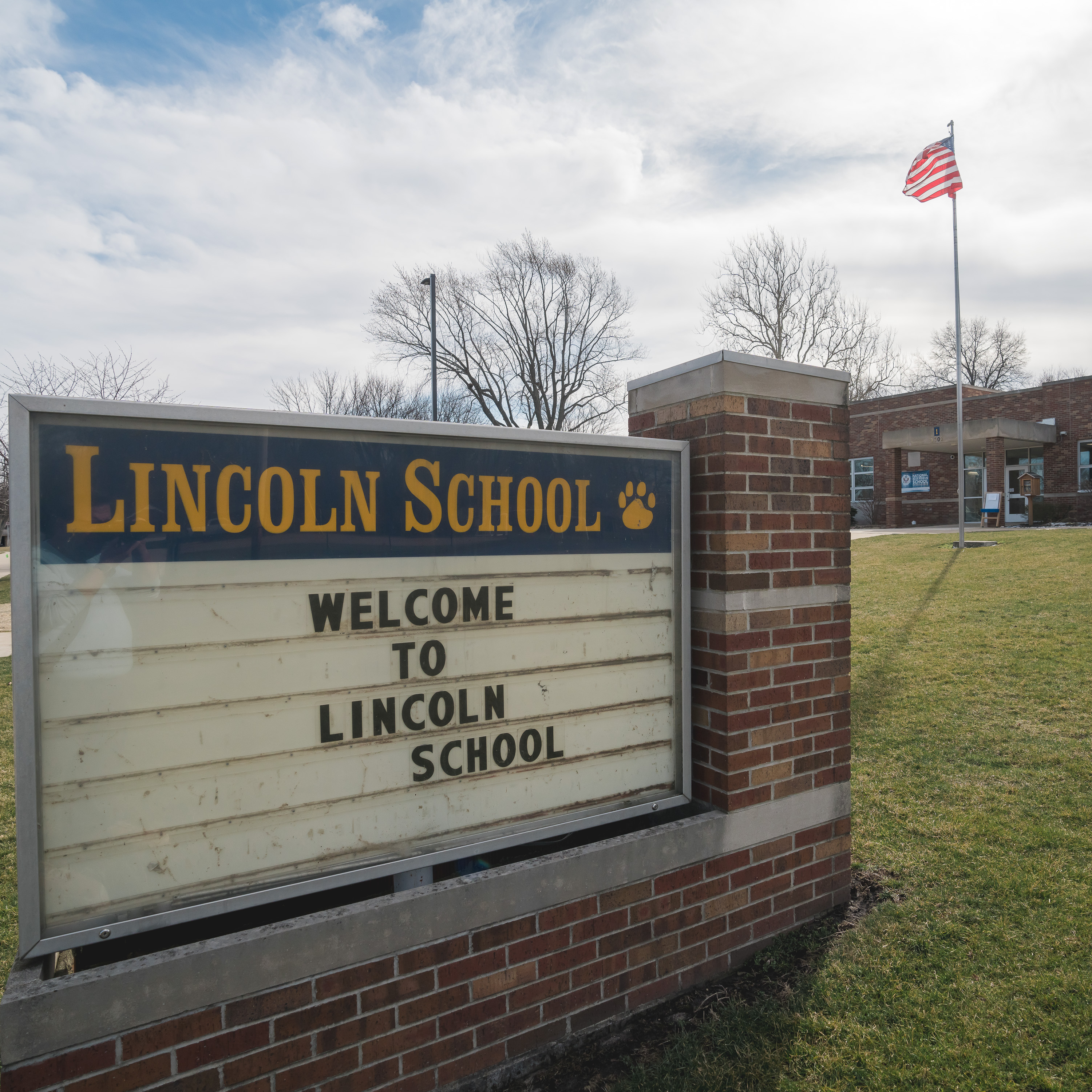 Lincoln school welcome sign and building