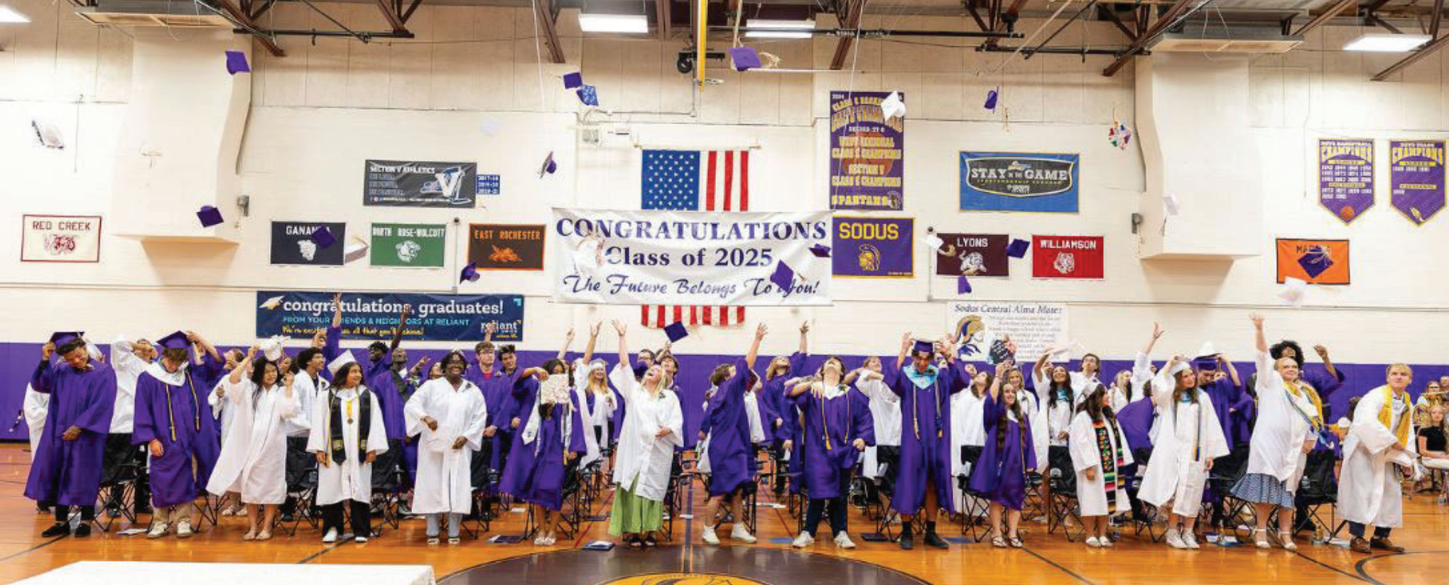 2025 graduates tossing their caps