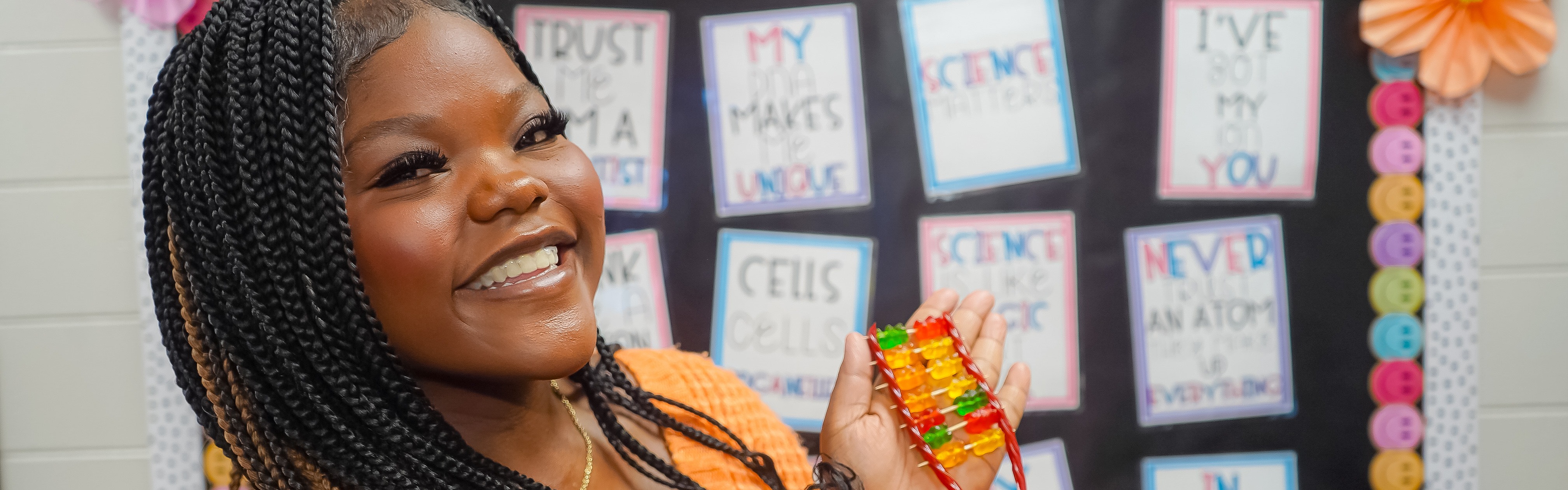 Student showing protein synthesis made out of candy