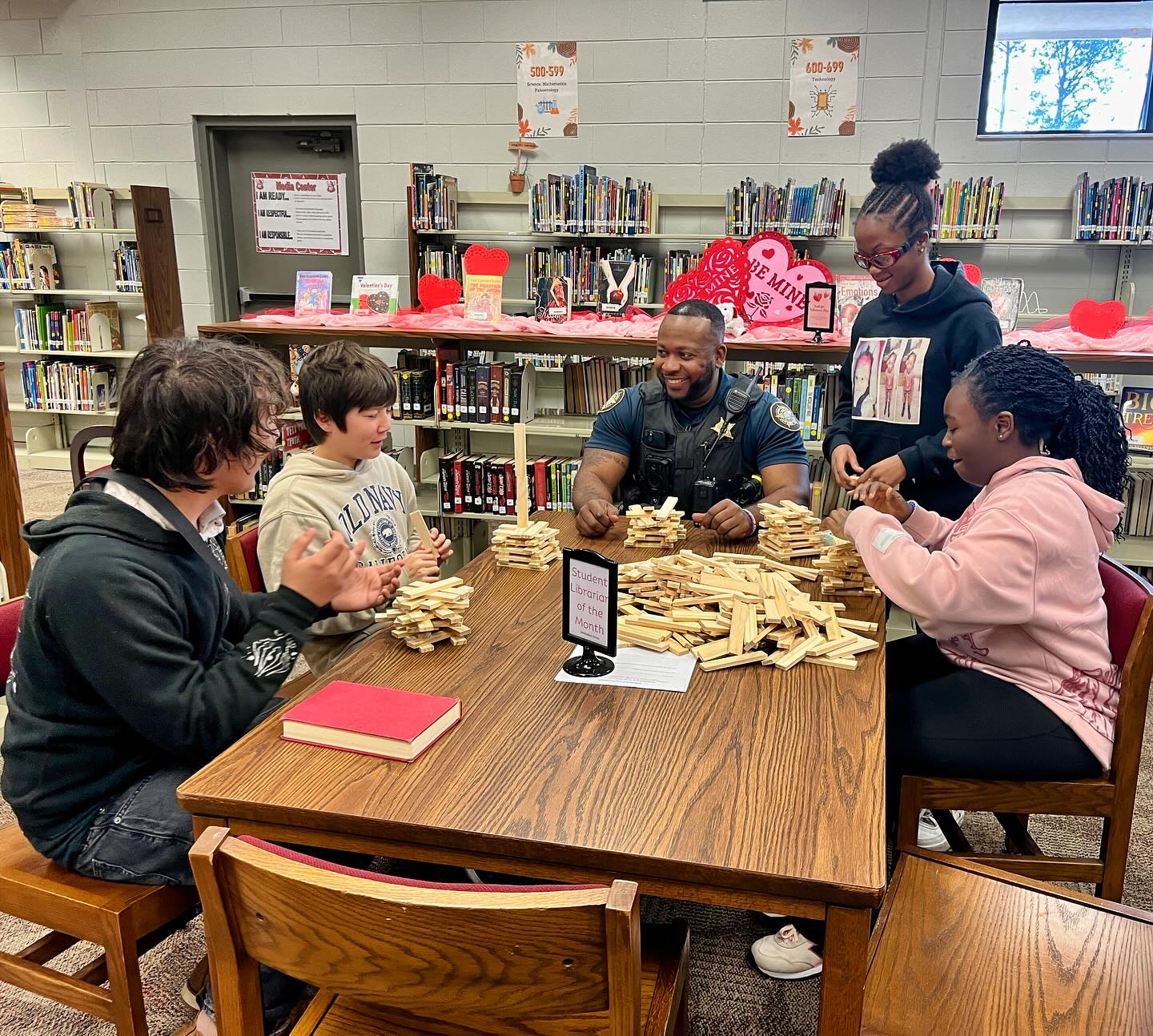 Officer Shaw with students in the media center