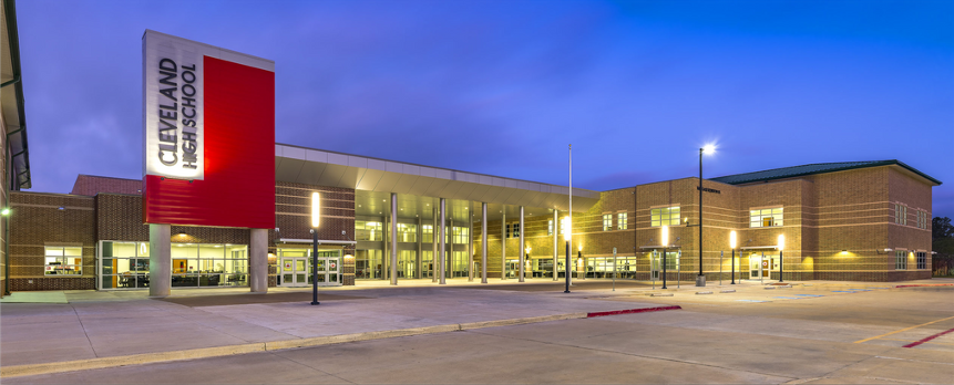 A wide shot of the CHS campus at night. Lights are on in the building