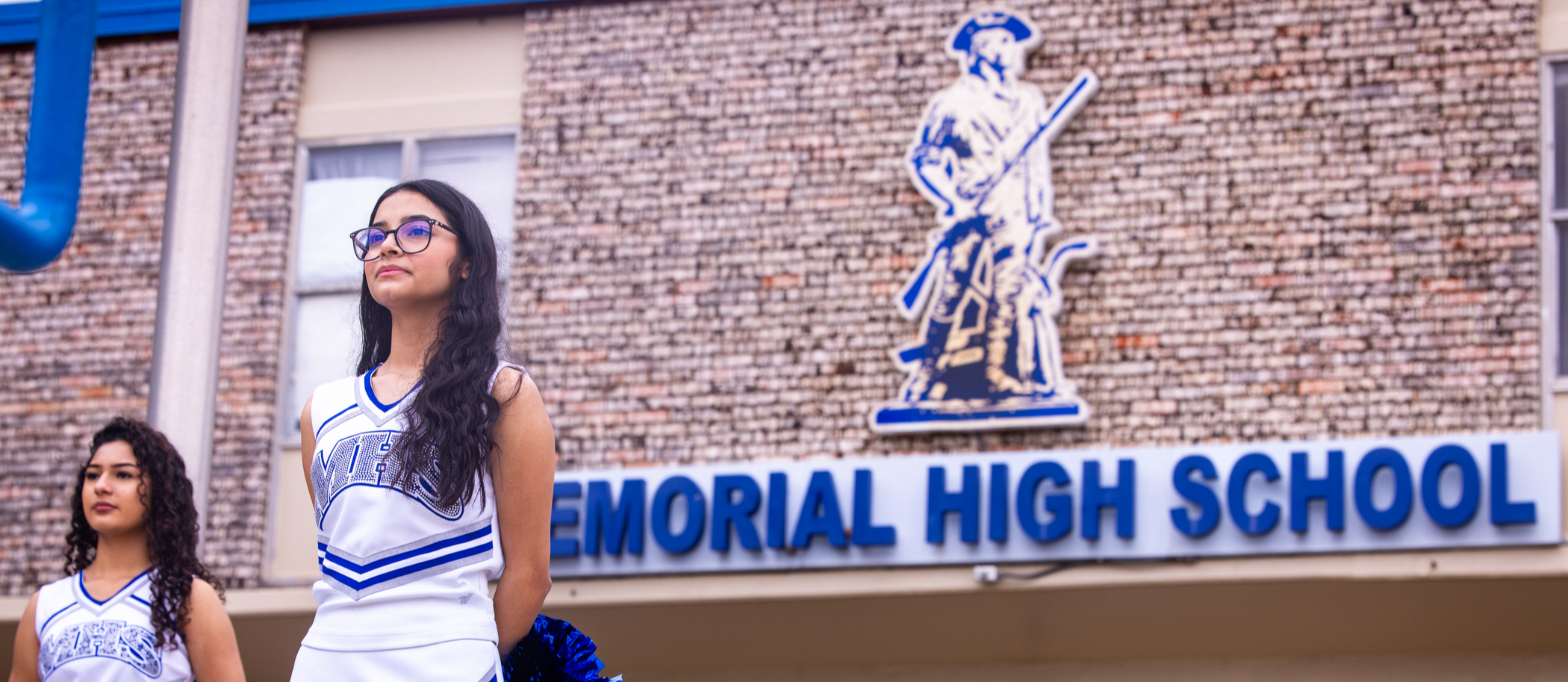 MHS cheerleader in front of the campus